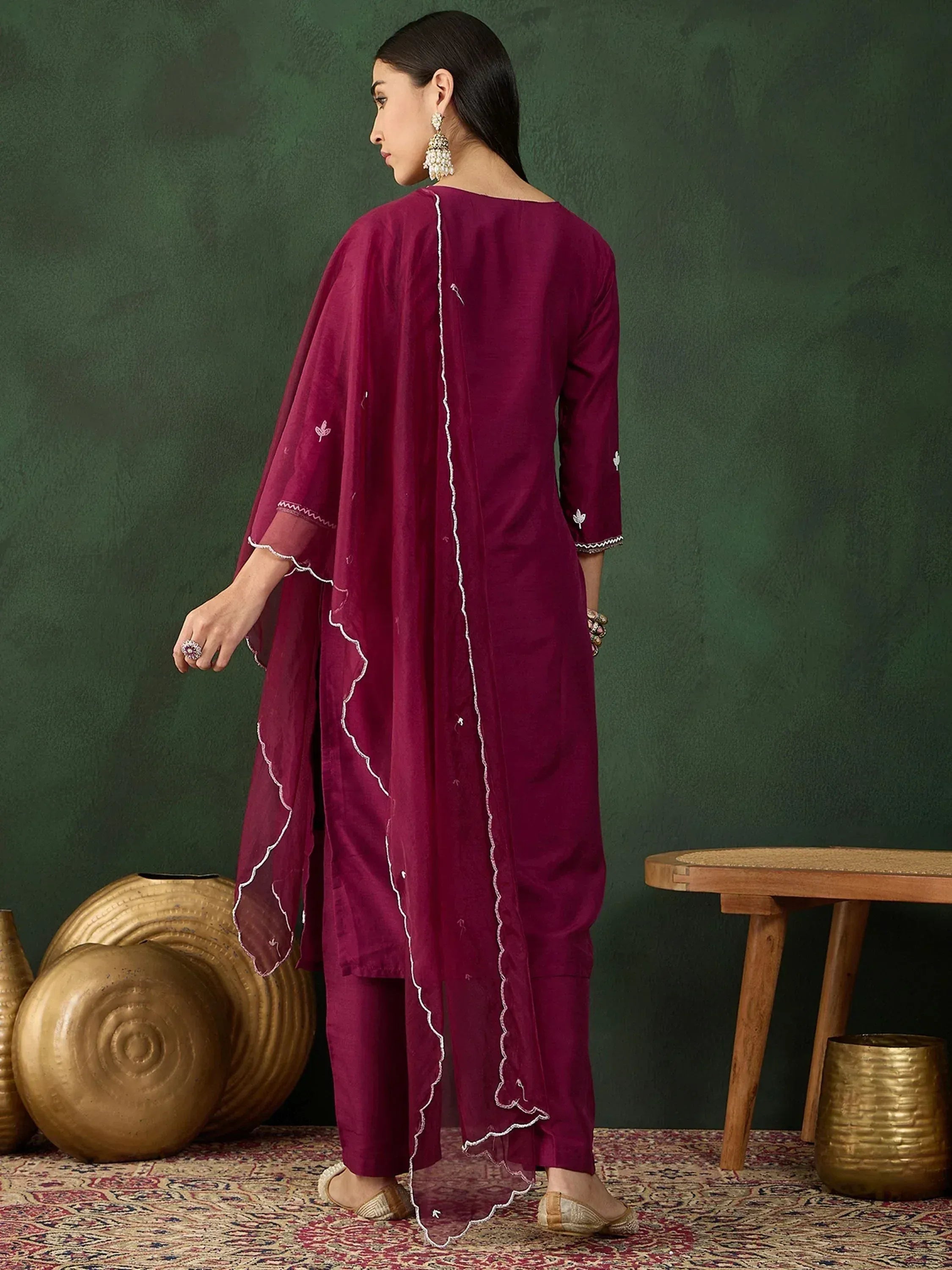 Maroon ethnic salwar kameez with white embroidery, paired with matching dupatta and traditional jewelry