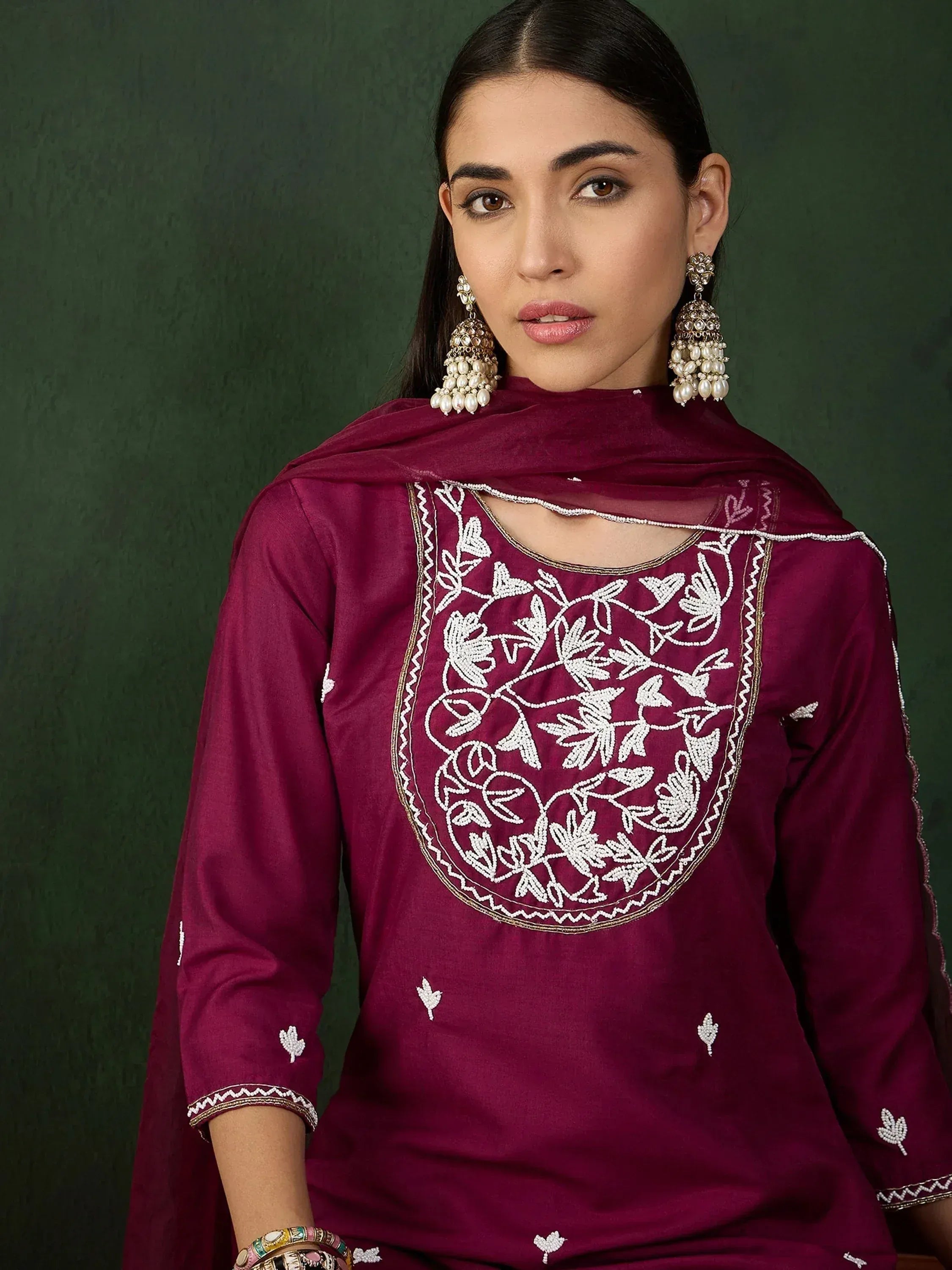 Maroon embroidered ethnic kurti with floral beadwork, paired with matching dupatta and jhumka earrings