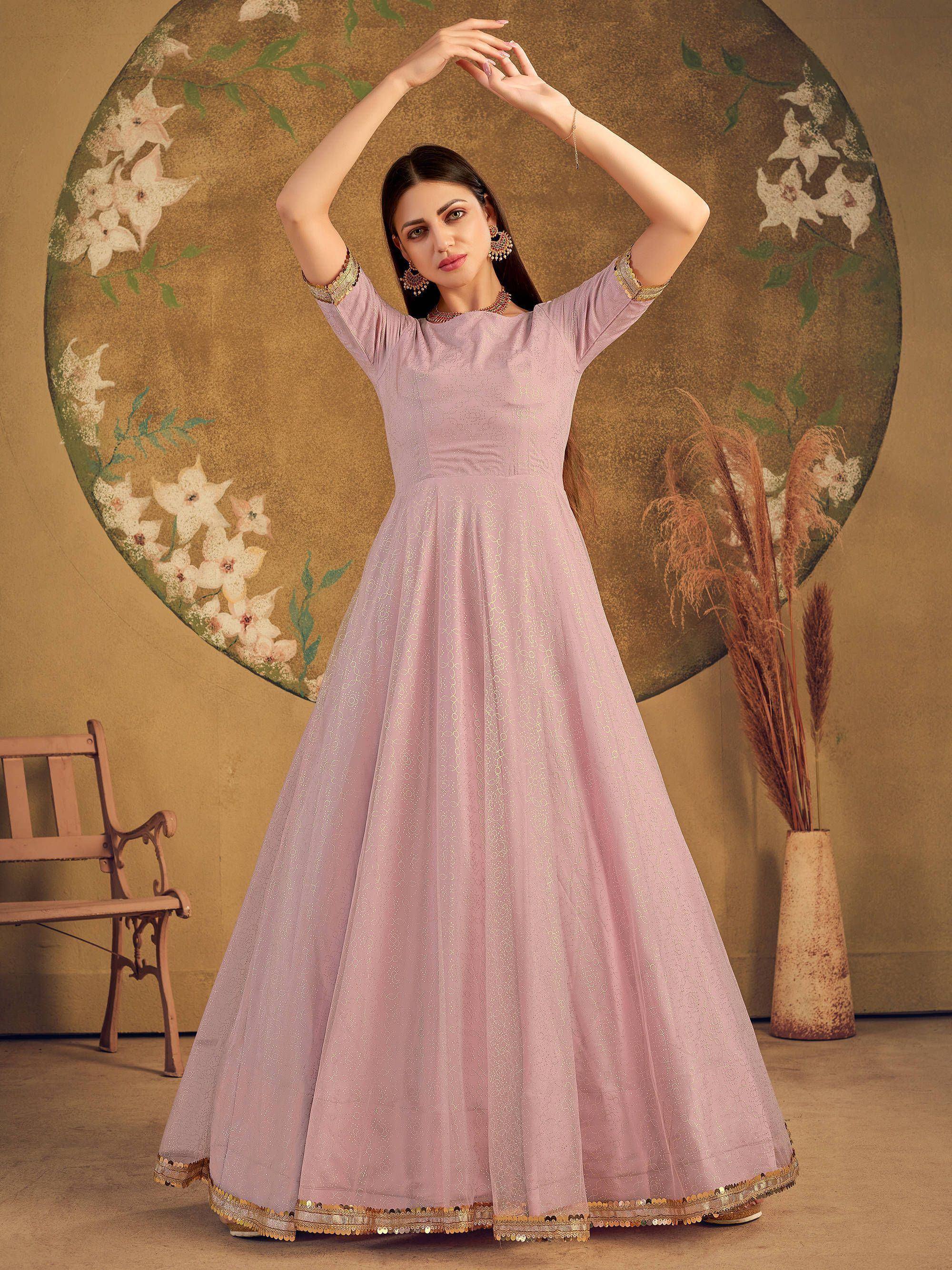 Elegant lavender ethnic gown with gold embroidery, perfect for Indian festive occasions and weddings.