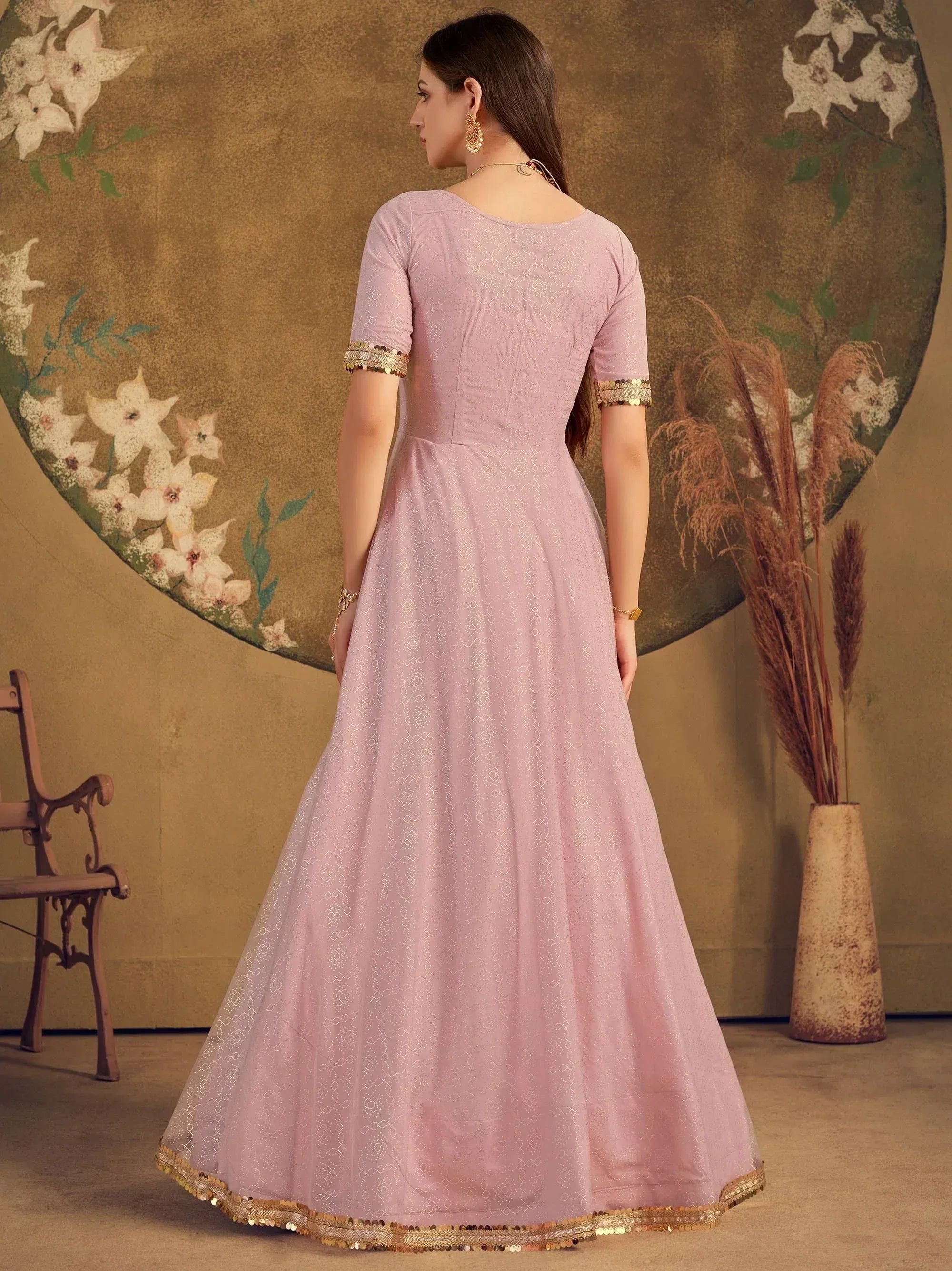 Elegant pink ethnic gown with gold sequin trim, perfect for Indian festive occasions and weddings.