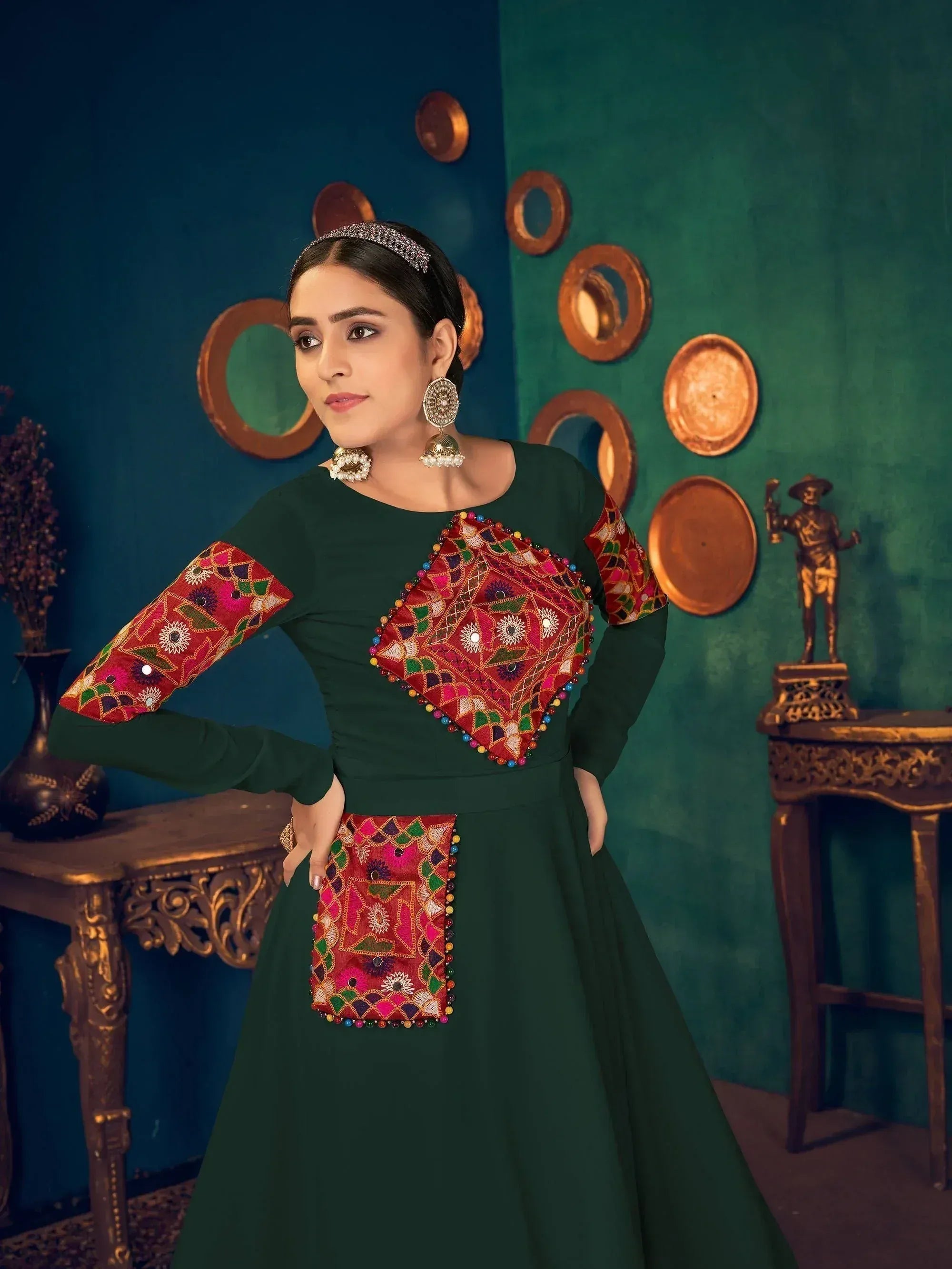 Green ethnic gown with vibrant mirror work and embroidery, perfect for Indian festive occasions
