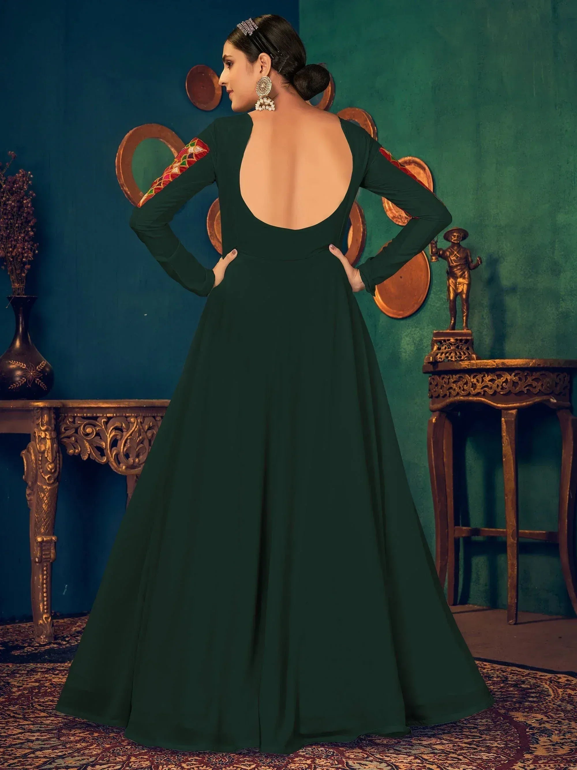 Emerald green ethnic gown with backless design and embroidered sleeves, perfect for Indian occasions