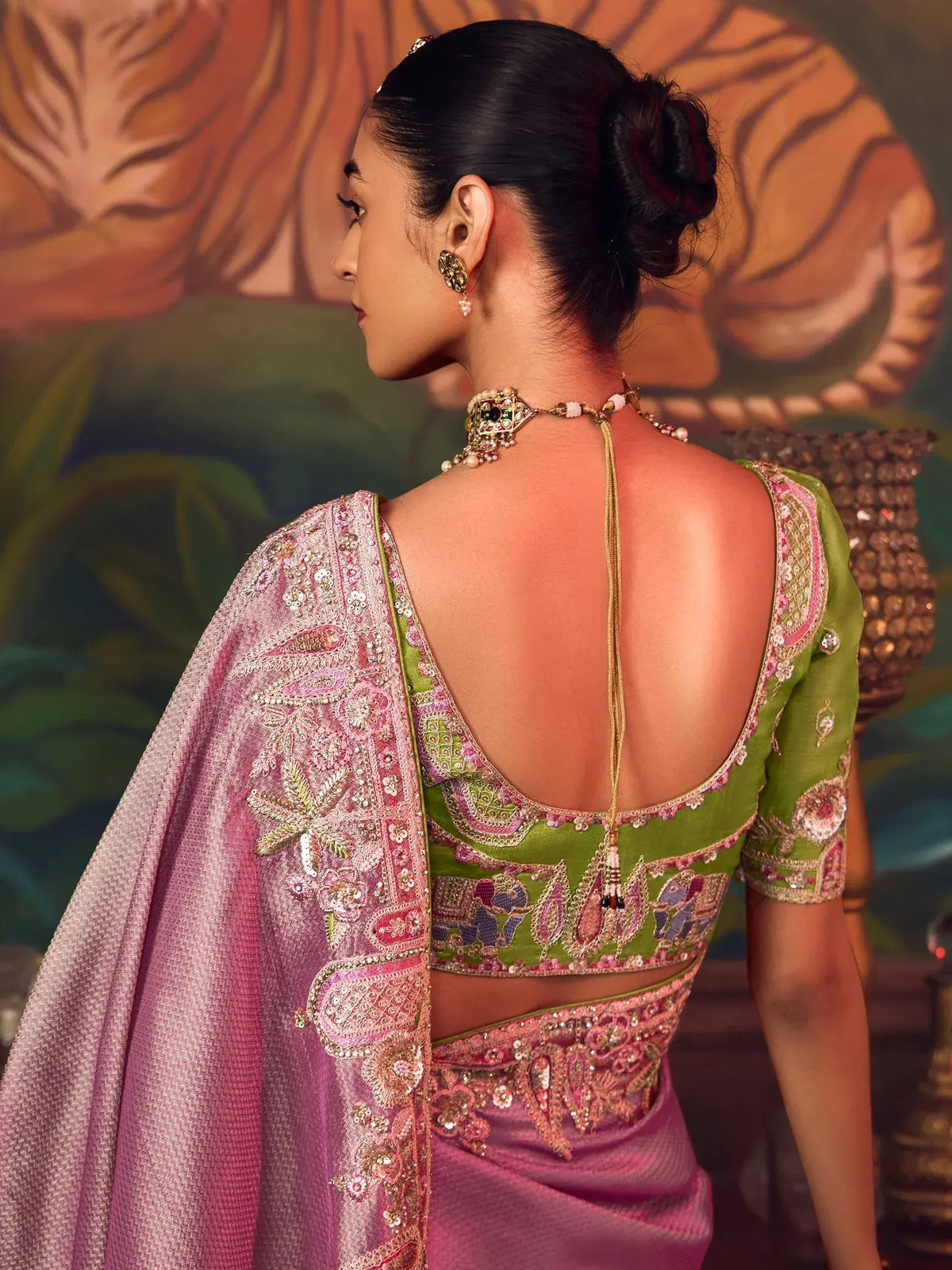 Elegant green and pink embroidered saree with open back design, perfect for Indian ethnic wear.