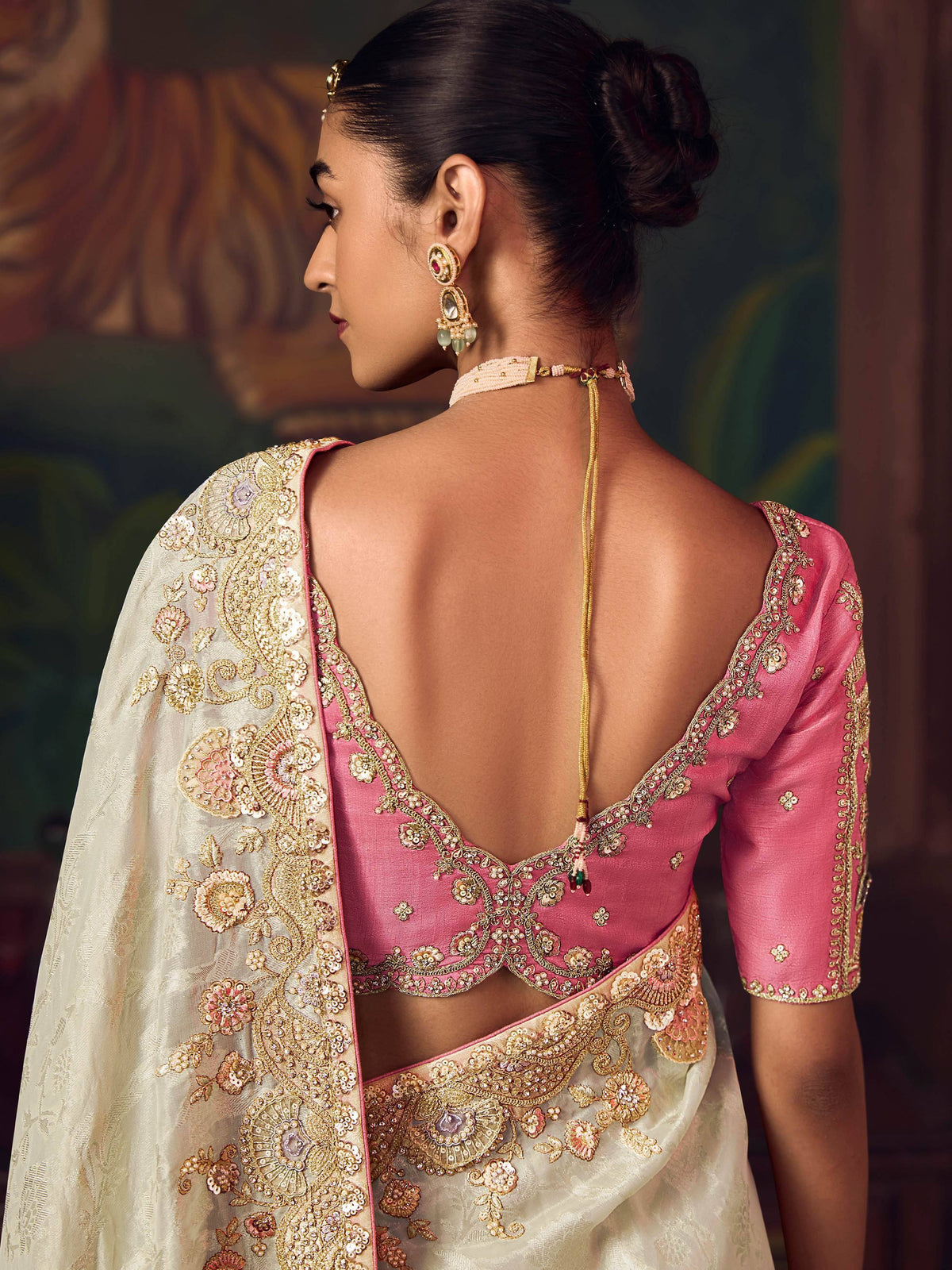 Elegant pink and gold embroidered saree with backless blouse and floral dupatta, perfect for Indian ethnic occasions.