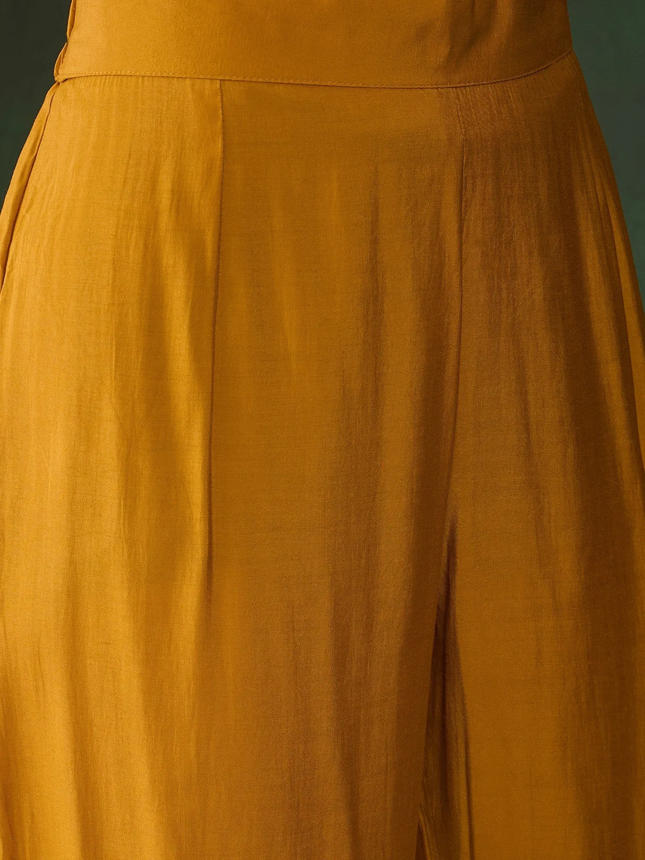 Mustard yellow ethnic gown with pleated skirt detail, perfect for Indian occasions