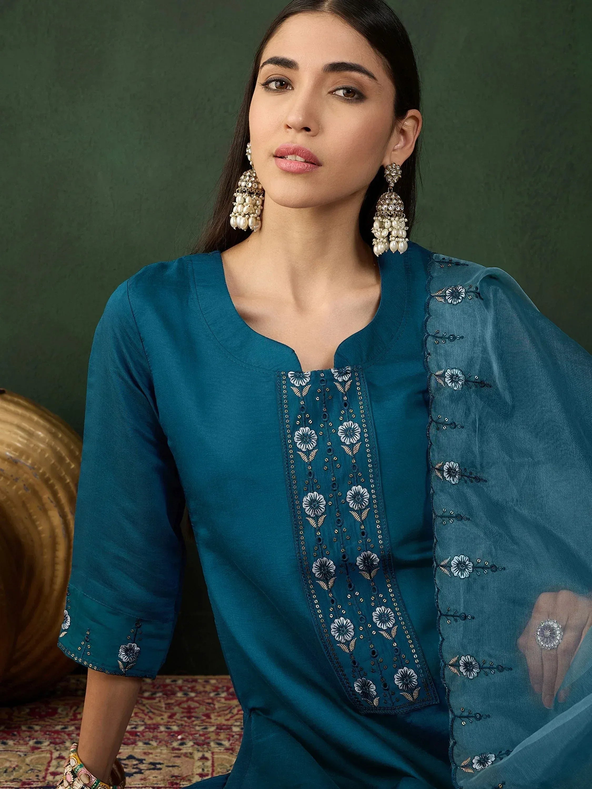Teal embroidered ethnic kurta with floral detailing, paired with statement pearl earrings for Indian wear