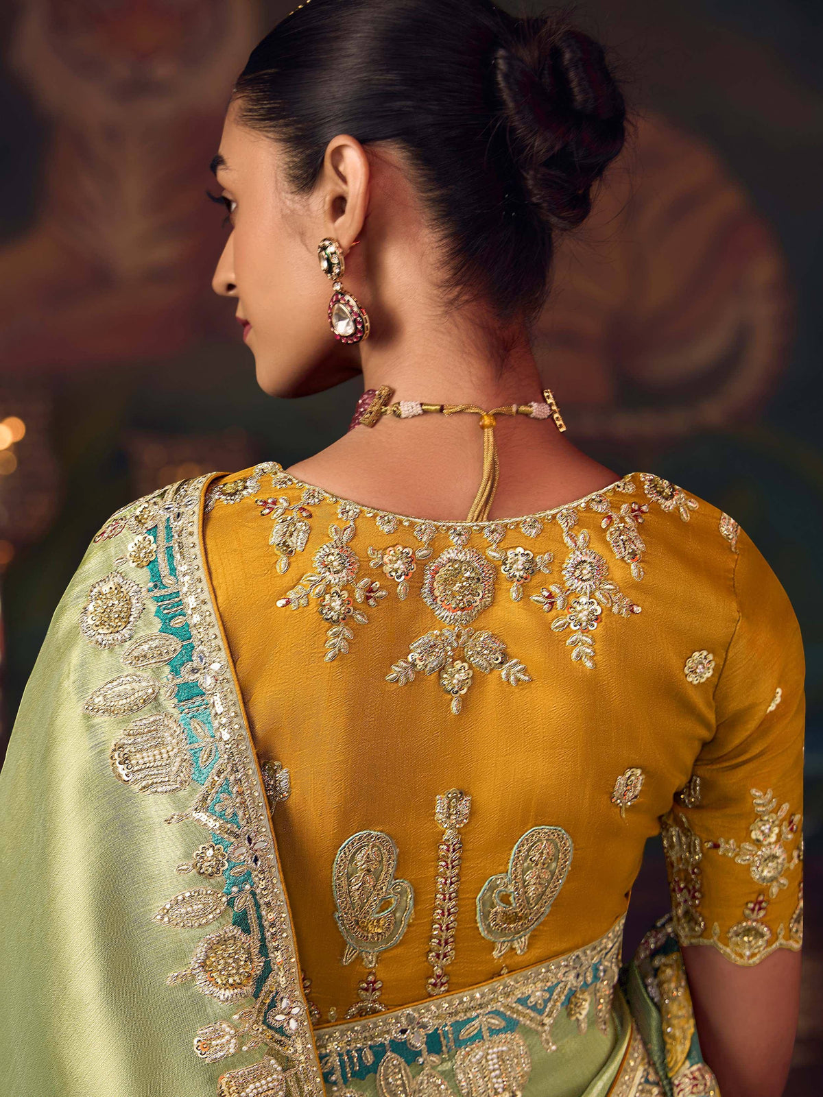Elegant mustard yellow designer saree with intricate floral embroidery and green border