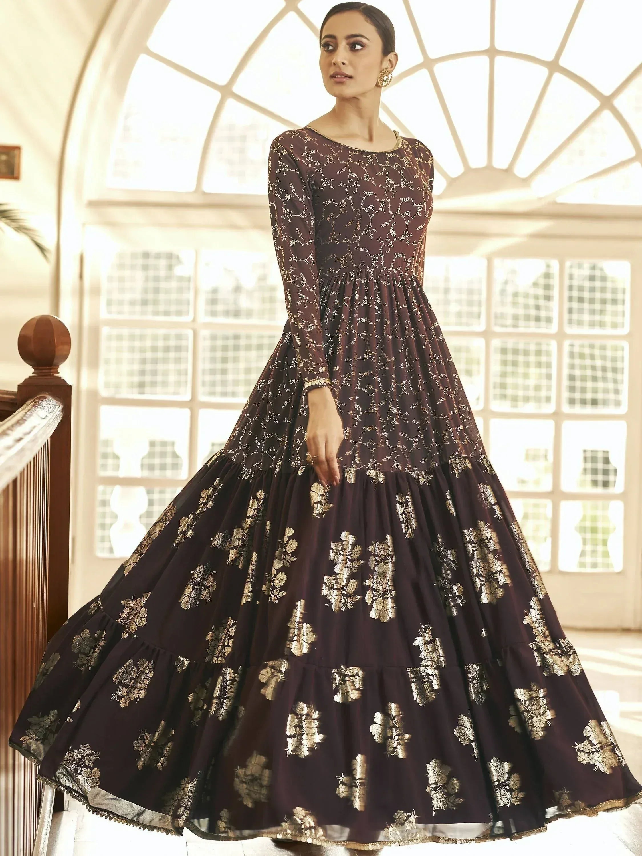 Elegant maroon ethnic gown with gold floral embroidery, perfect for Indian festive occasions