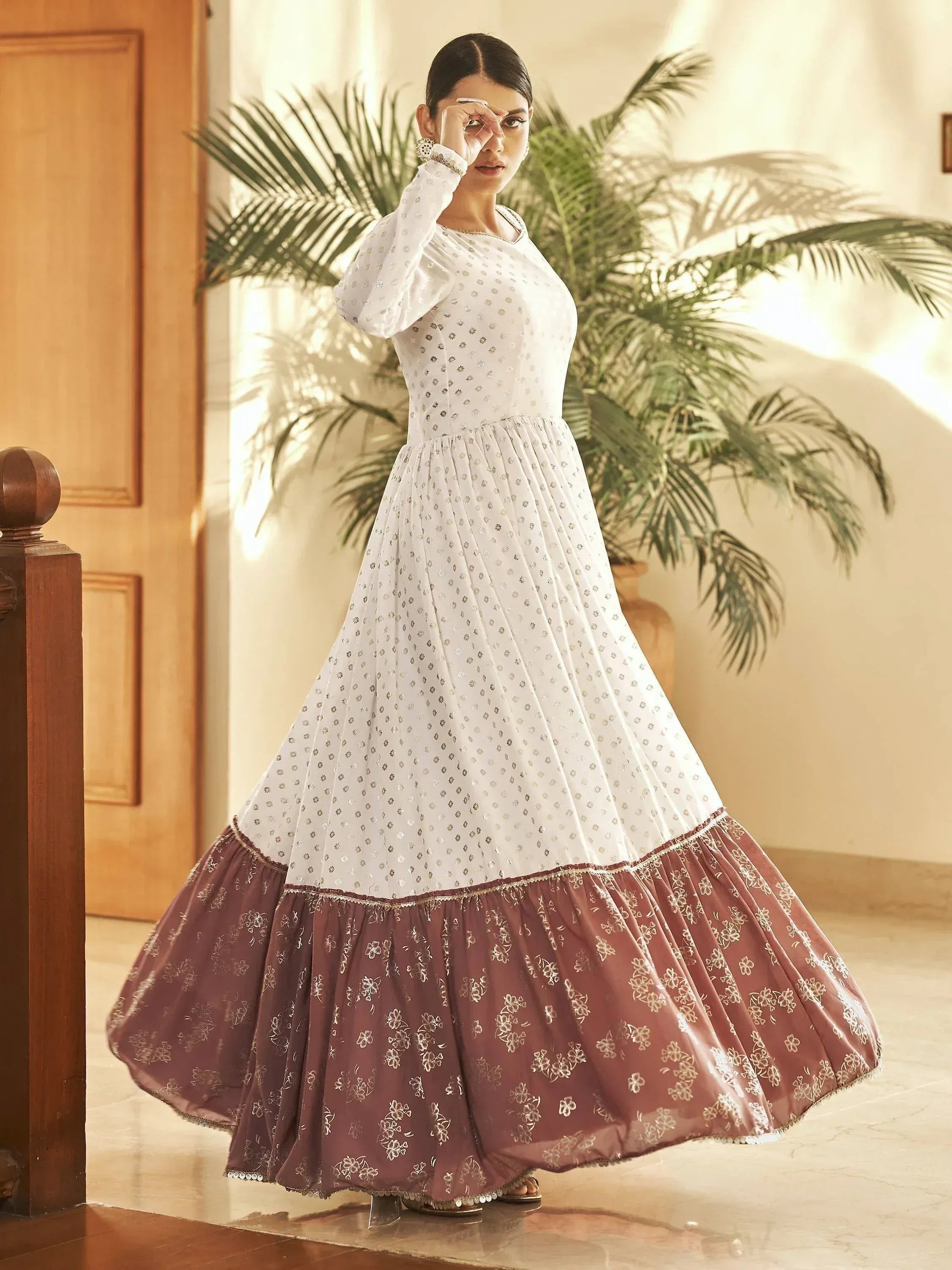 Elegant white and maroon ethnic gown with floral embroidery, perfect for Indian celebrations.