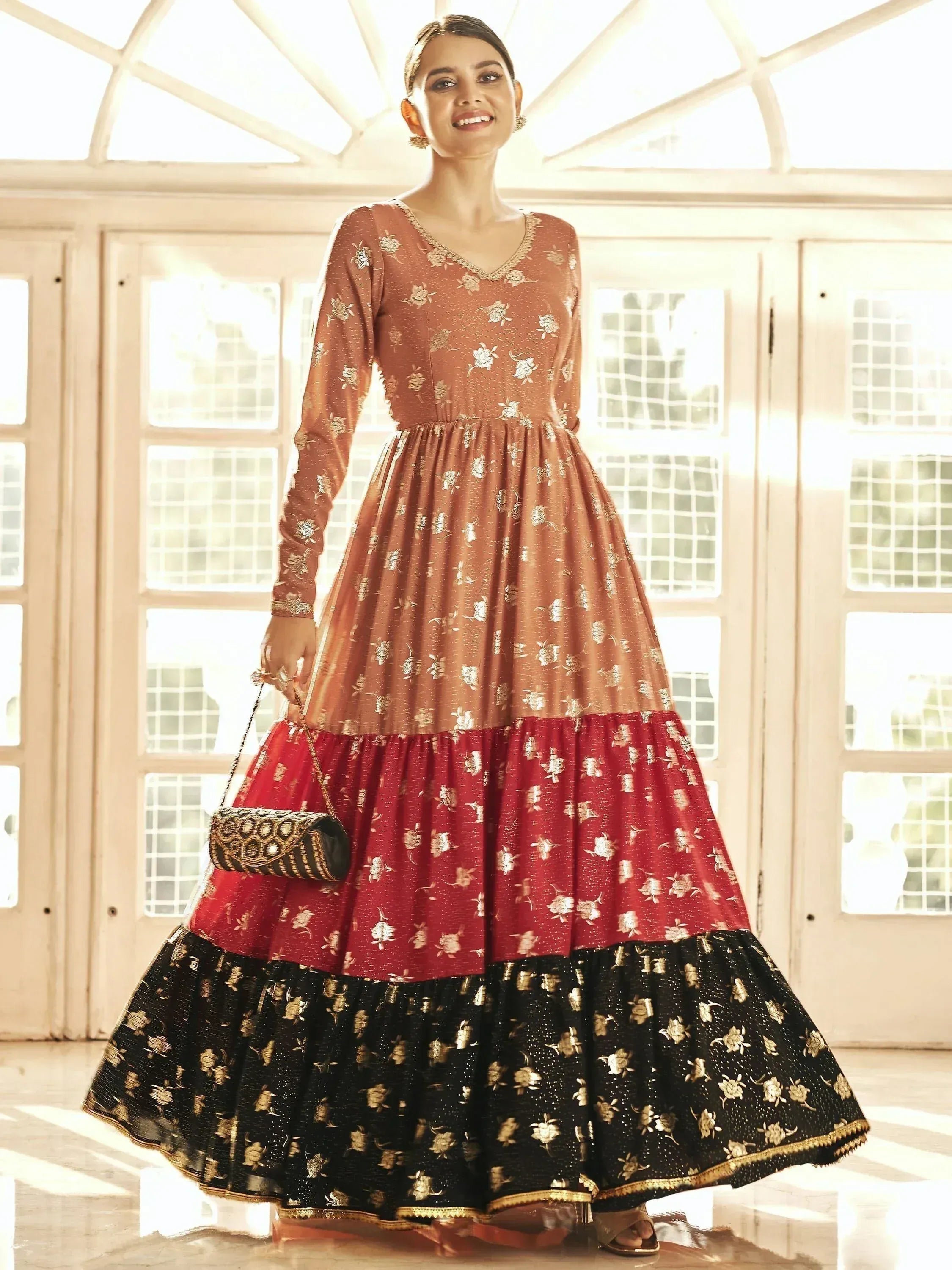 Elegant Indian ethnic gown with floral embroidery, tiered skirt in red and black, perfect for festive occasions.
