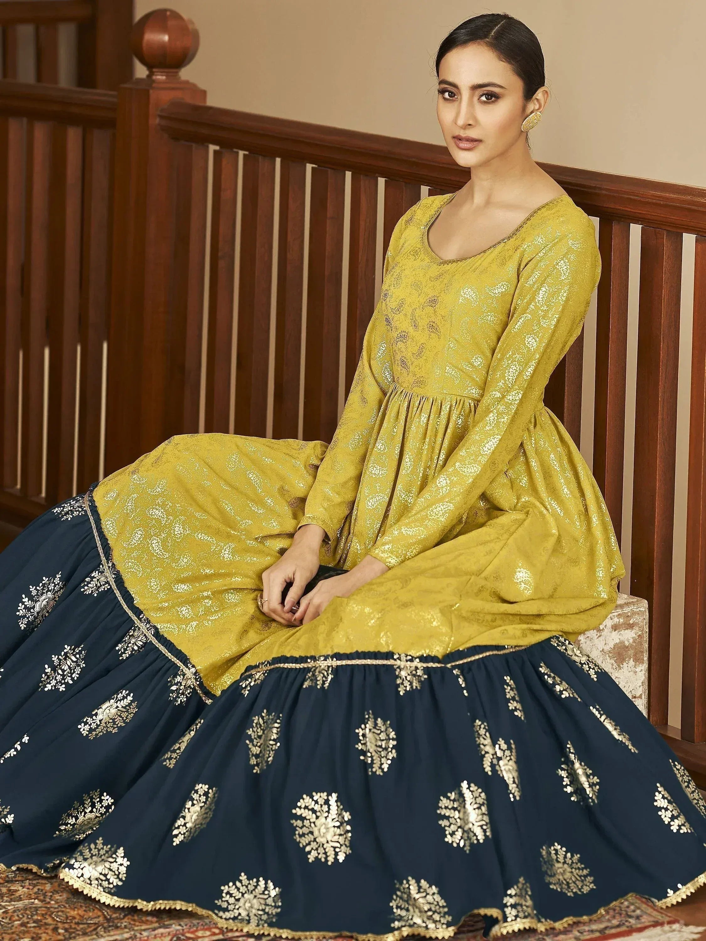 Elegant mustard yellow and navy blue embroidered lehenga choli with gold detailing, perfect for ethnic occasions.