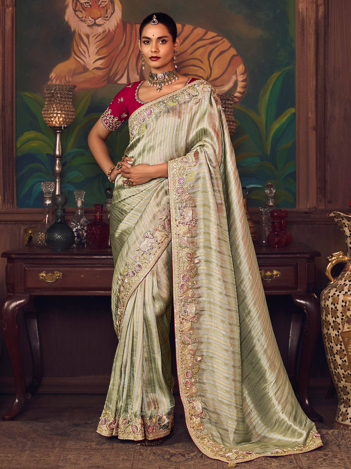 Elegant green striped saree with floral embroidery and red blouse, perfect for Indian ethnic wear occasions.