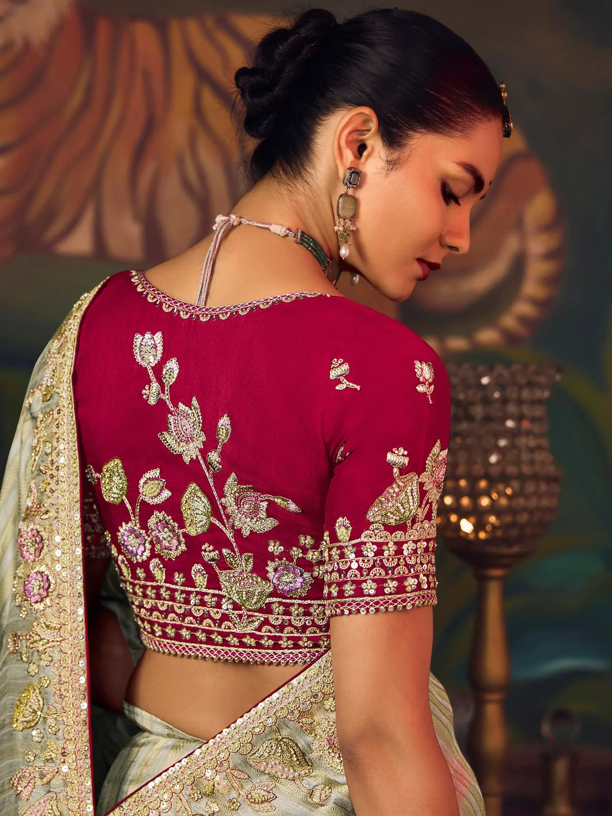 Elegant maroon blouse with floral embroidery paired with a designer saree for ethnic wear