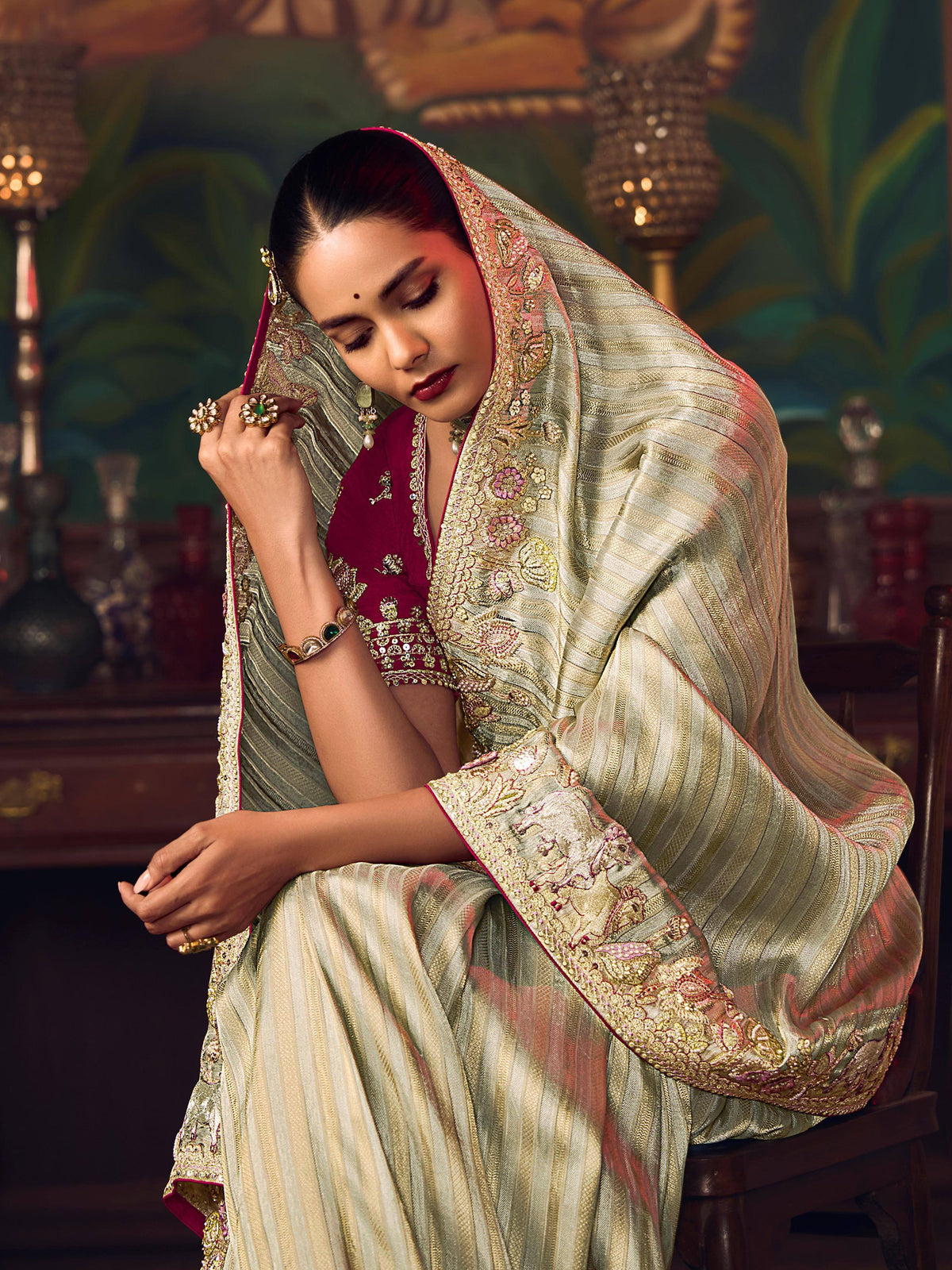Elegant woman in designer lehenga choli with intricate embroidery and gold detailing, showcasing Indian ethnic wear.