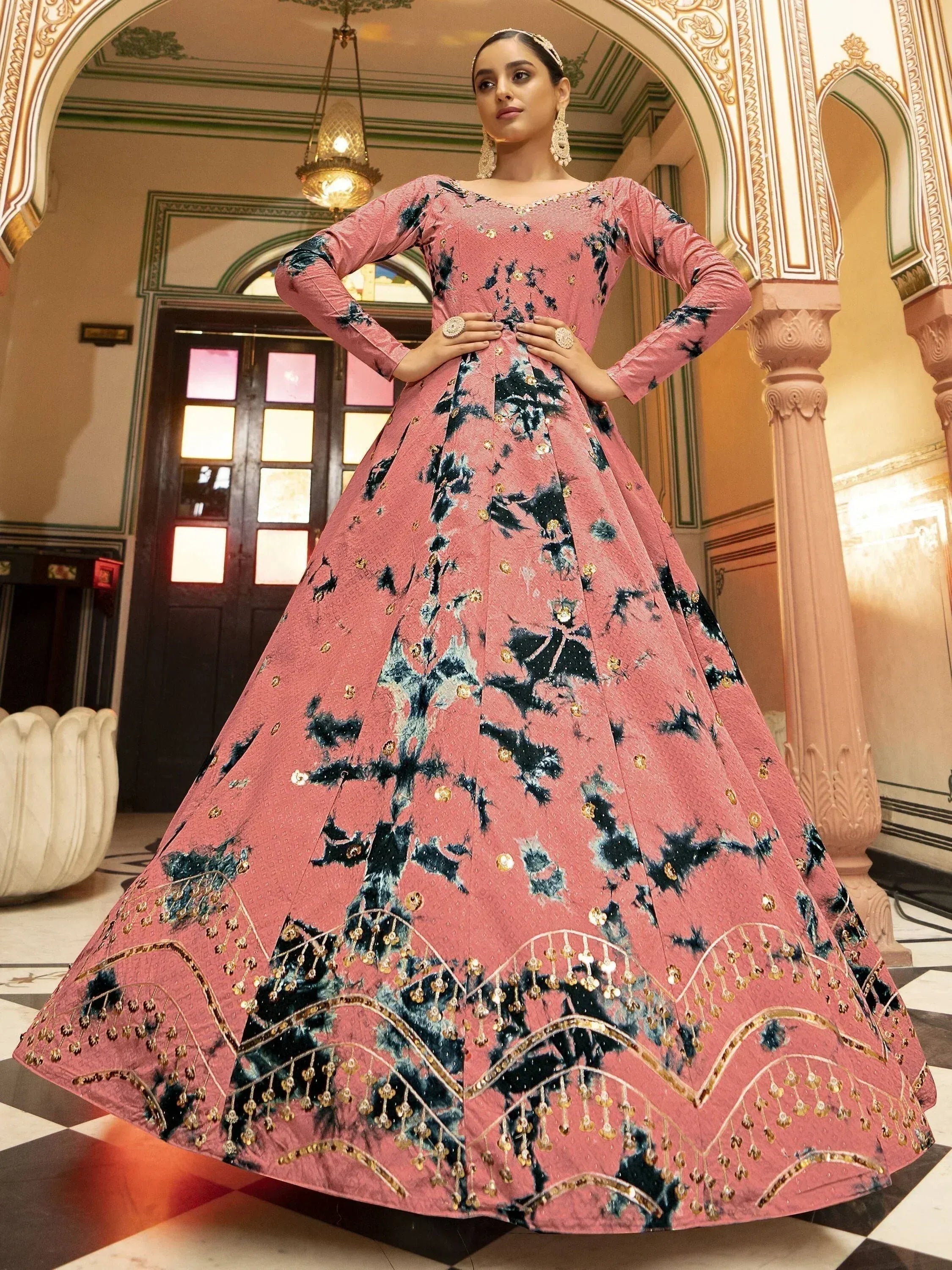 Pink floral embroidered ethnic gown with gold detailing, perfect for Indian weddings and festive occasions.