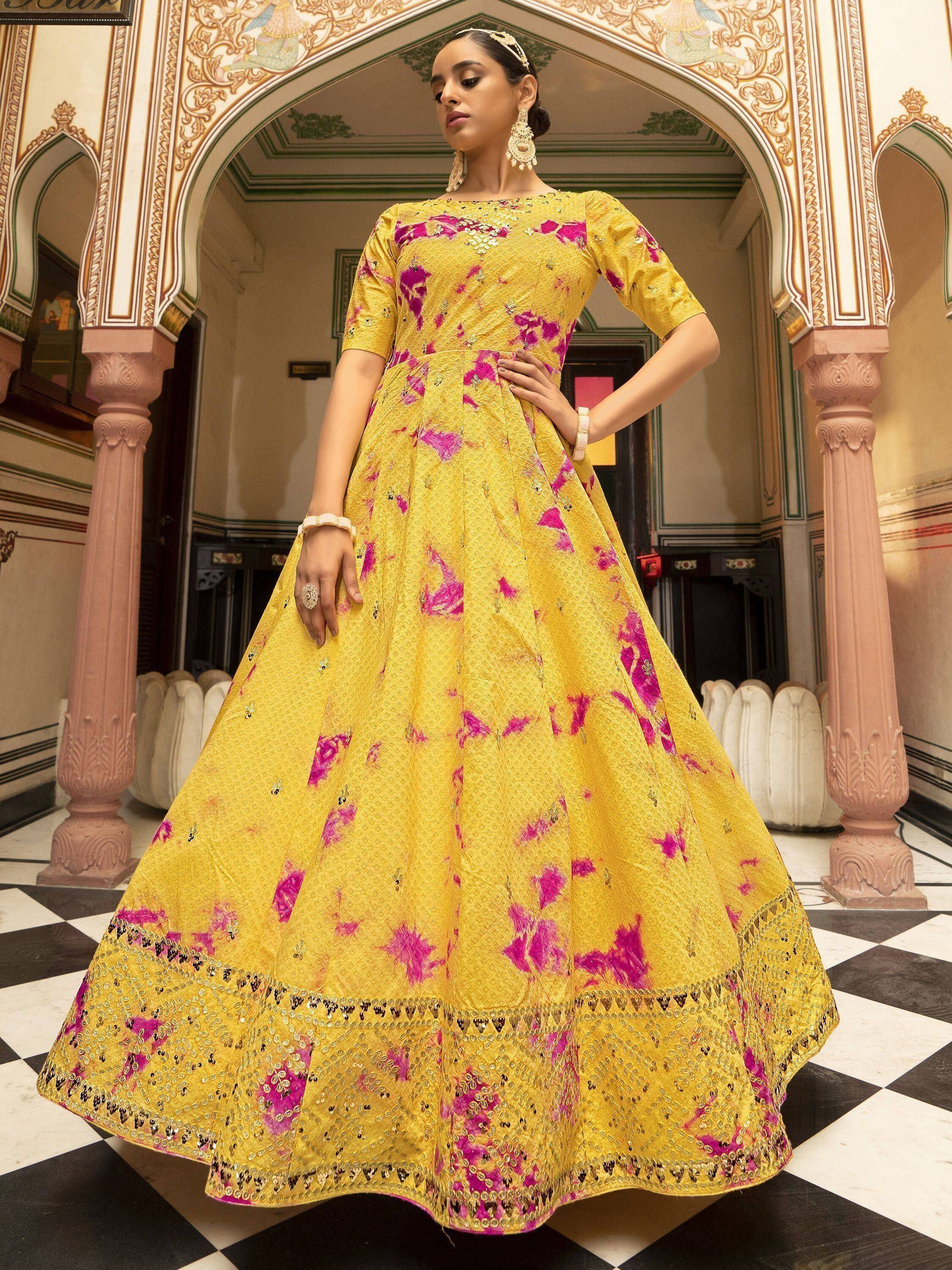 Yellow and pink floral ethnic gown with sequin detailing, perfect for Indian weddings and festive occasions.