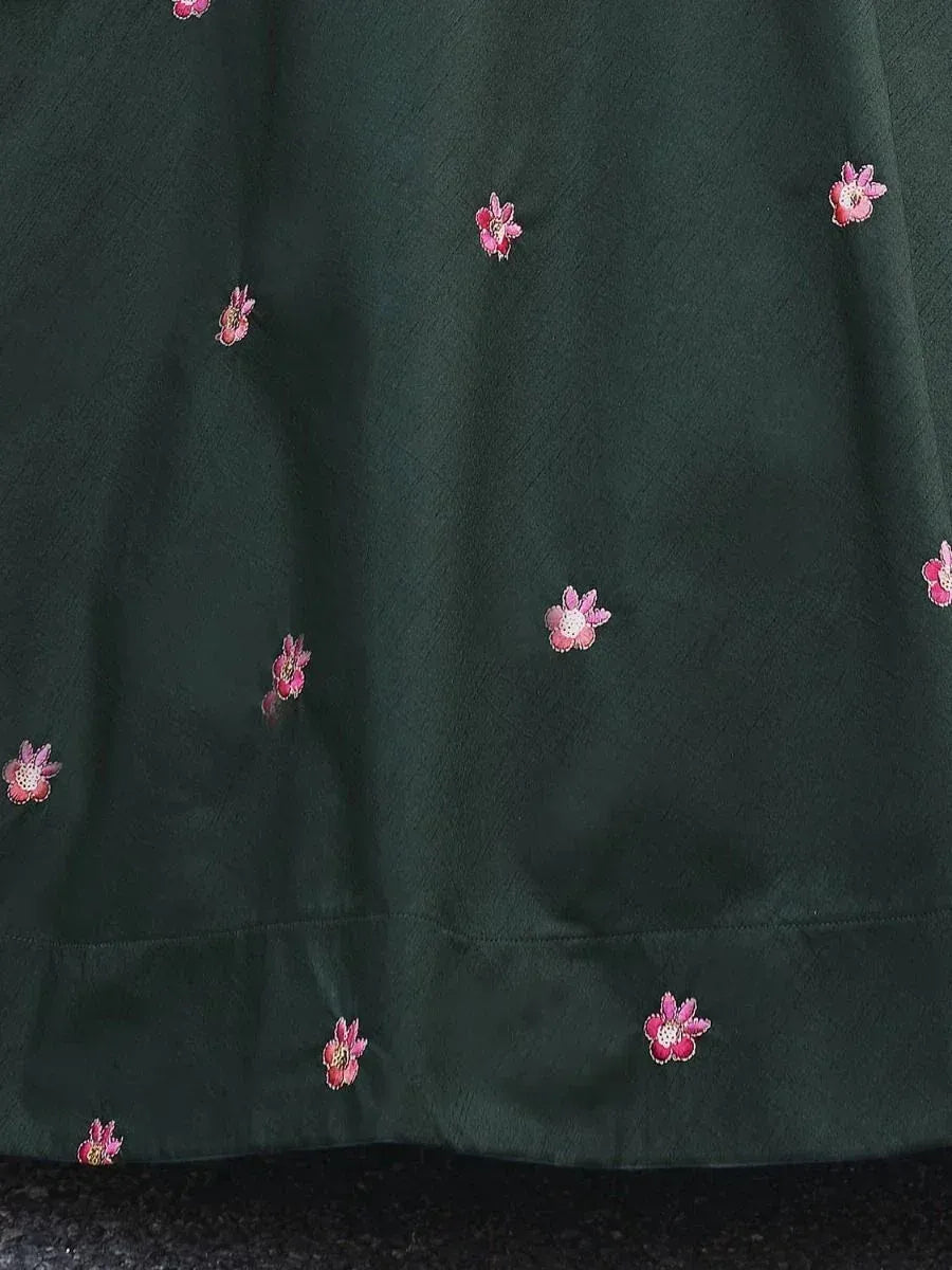 Dark green ethnic gown with pink floral embroidery, perfect for Indian occasions