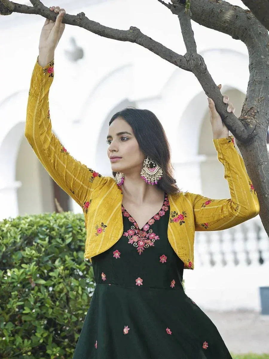 Woman in green floral embroidered gown with yellow jacket, ethnic wear for festive occasions