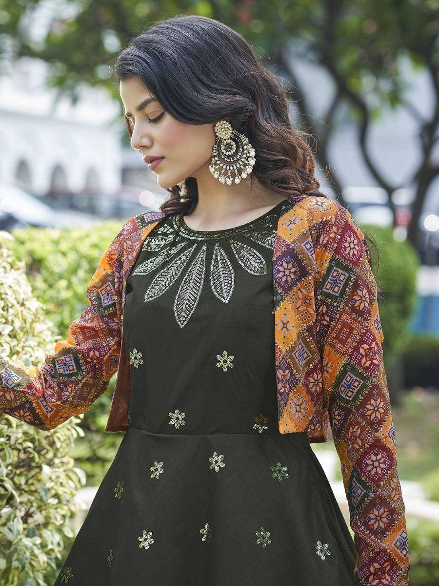 Woman in black embroidered ethnic gown with colorful patterned jacket, perfect for Indian occasions.