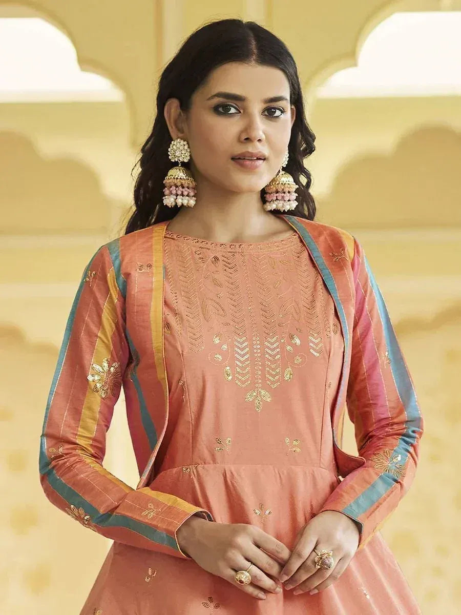 Peach designer ethnic gown with gold embroidery and colorful stripes, paired with jhumka earrings