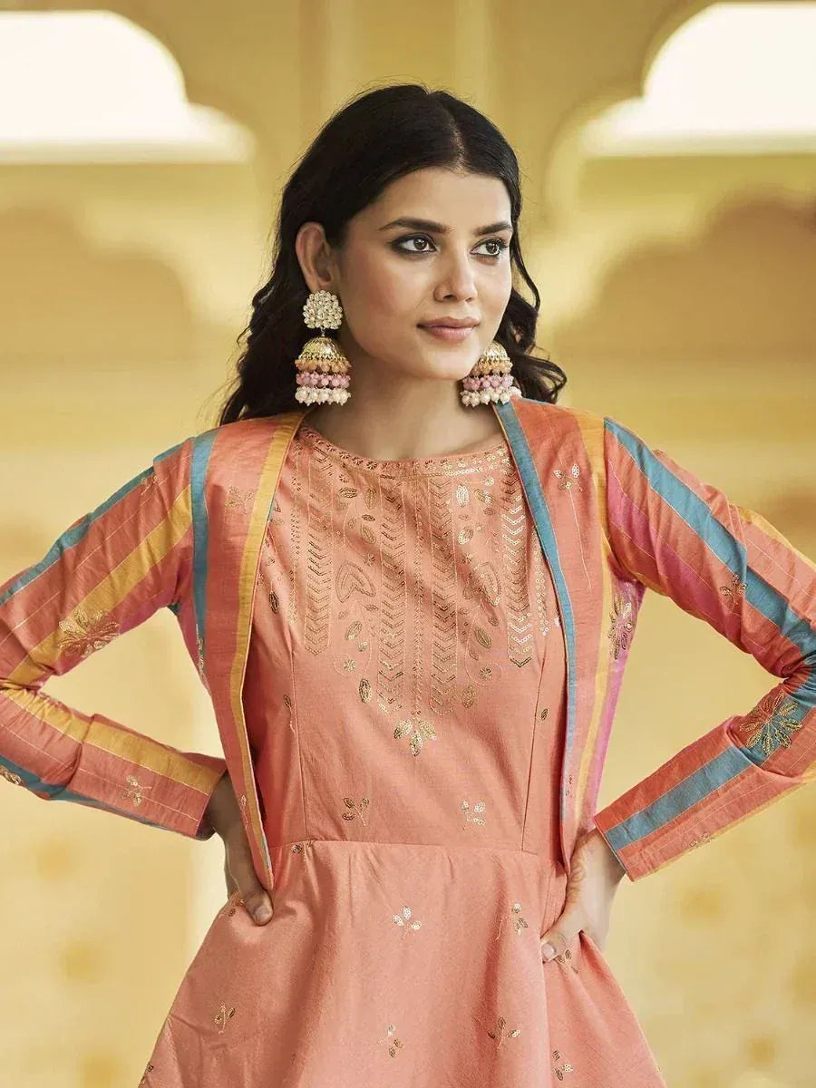 Peach embroidered ethnic kurta with striped sleeves and gold detailing, styled with jhumka earrings