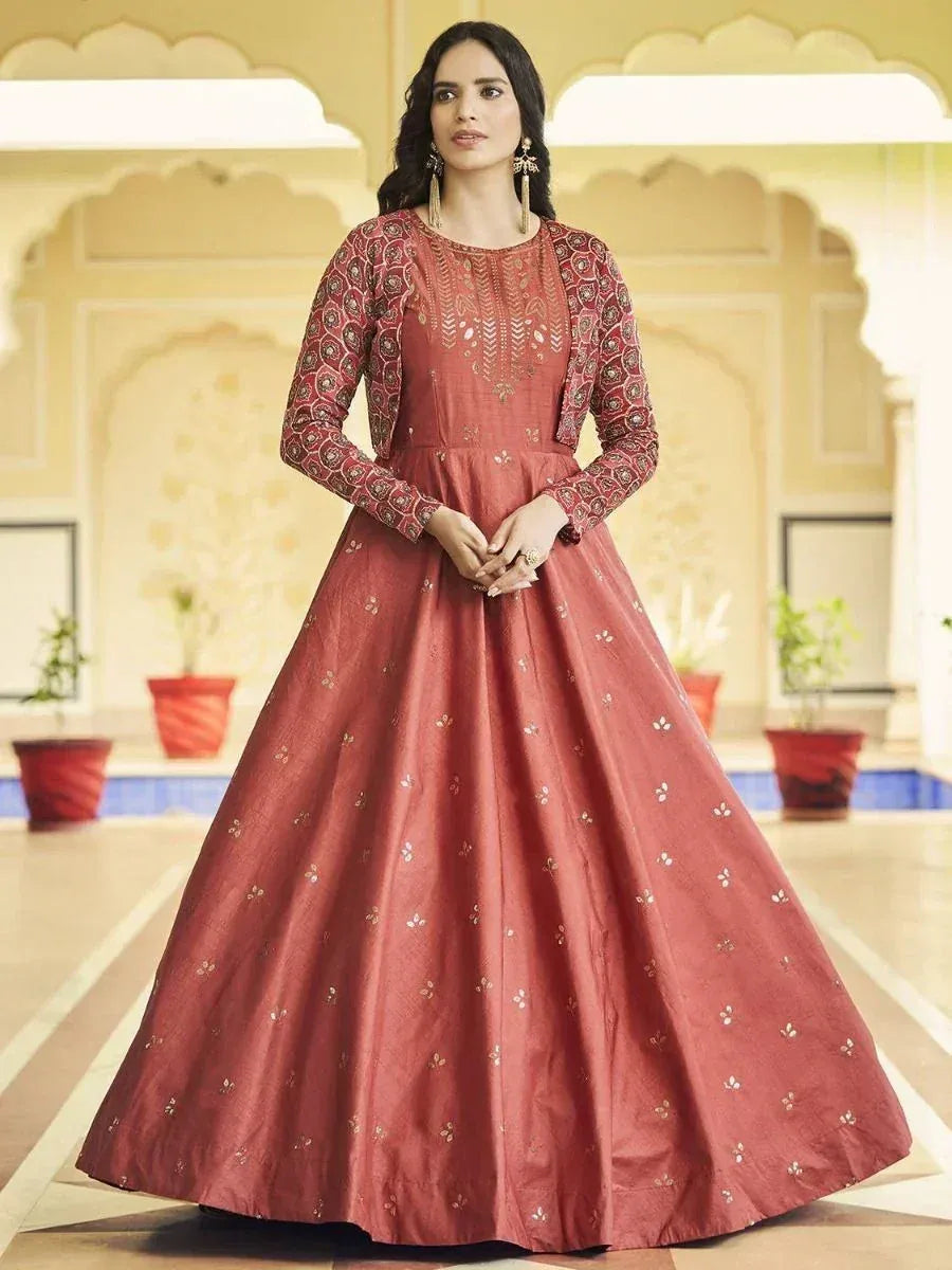 Elegant maroon ethnic gown with gold embroidery, perfect for Indian weddings and festive occasions.