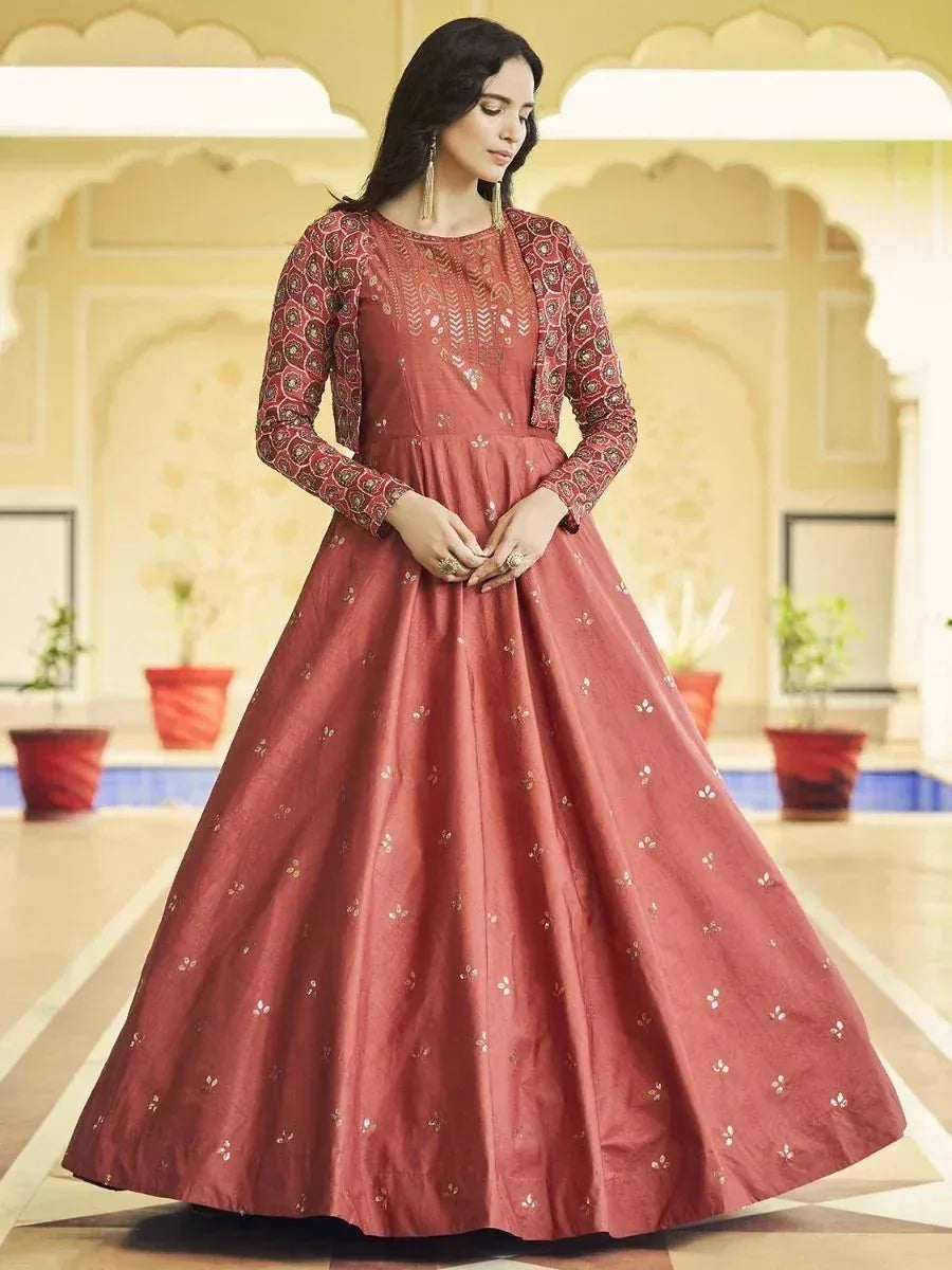 Elegant maroon ethnic gown with gold embroidery, perfect for Indian weddings and festive occasions.