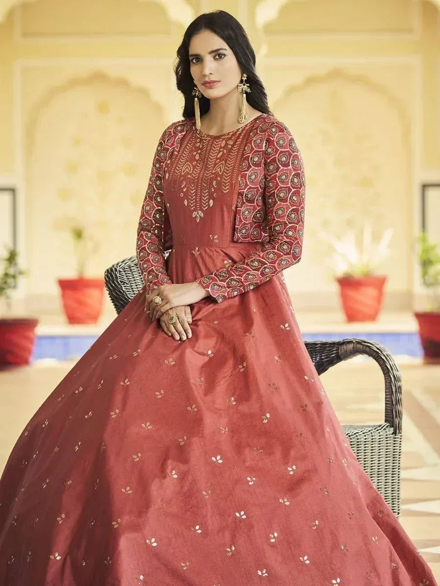 Elegant maroon ethnic gown with gold embroidery, perfect for Indian weddings and festive occasions