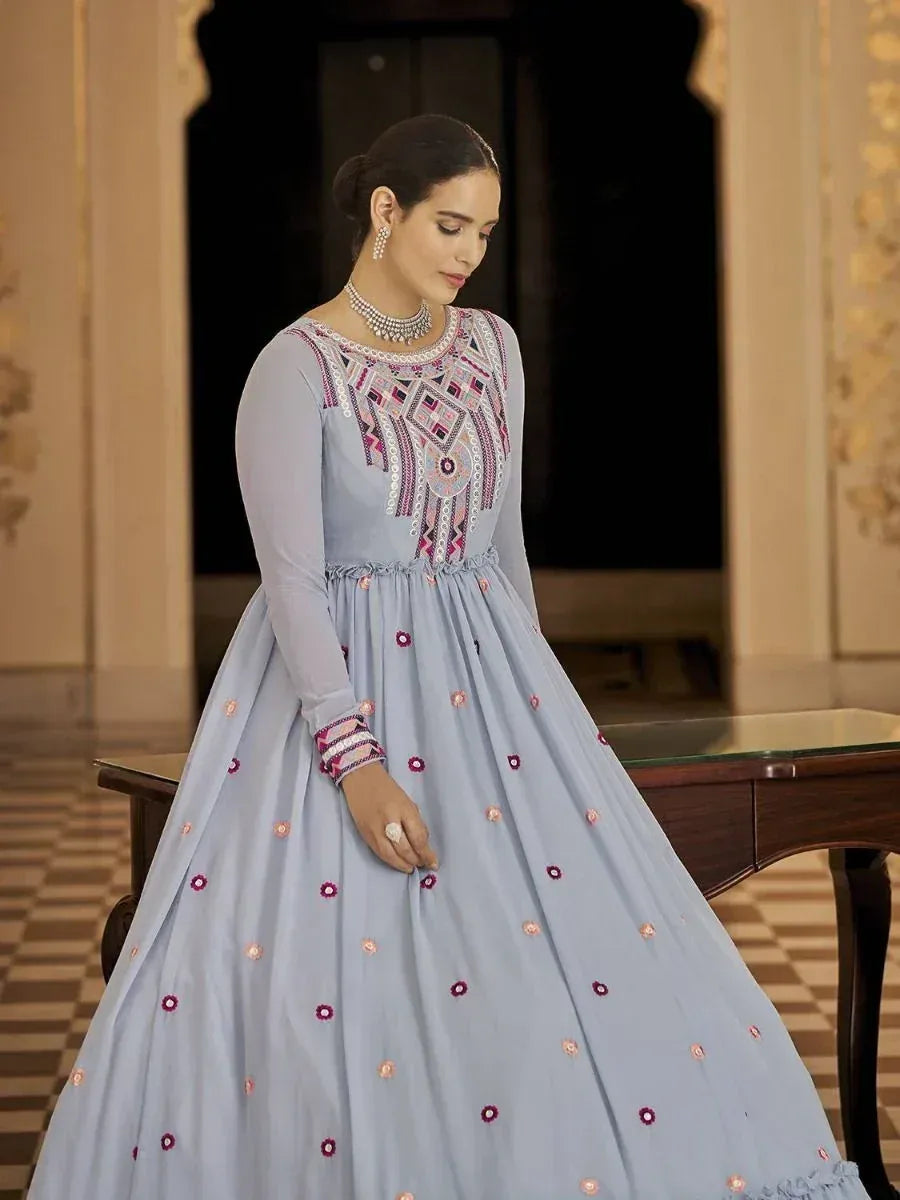Light blue ethnic gown with intricate embroidery and mirror work, perfect for Indian festive occasions