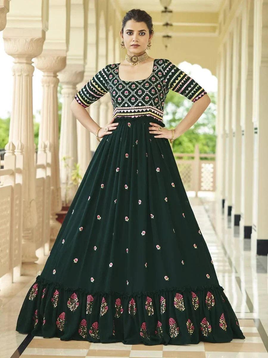 Woman in dark green embroidered lehenga gown with half sleeves and floral patterns
