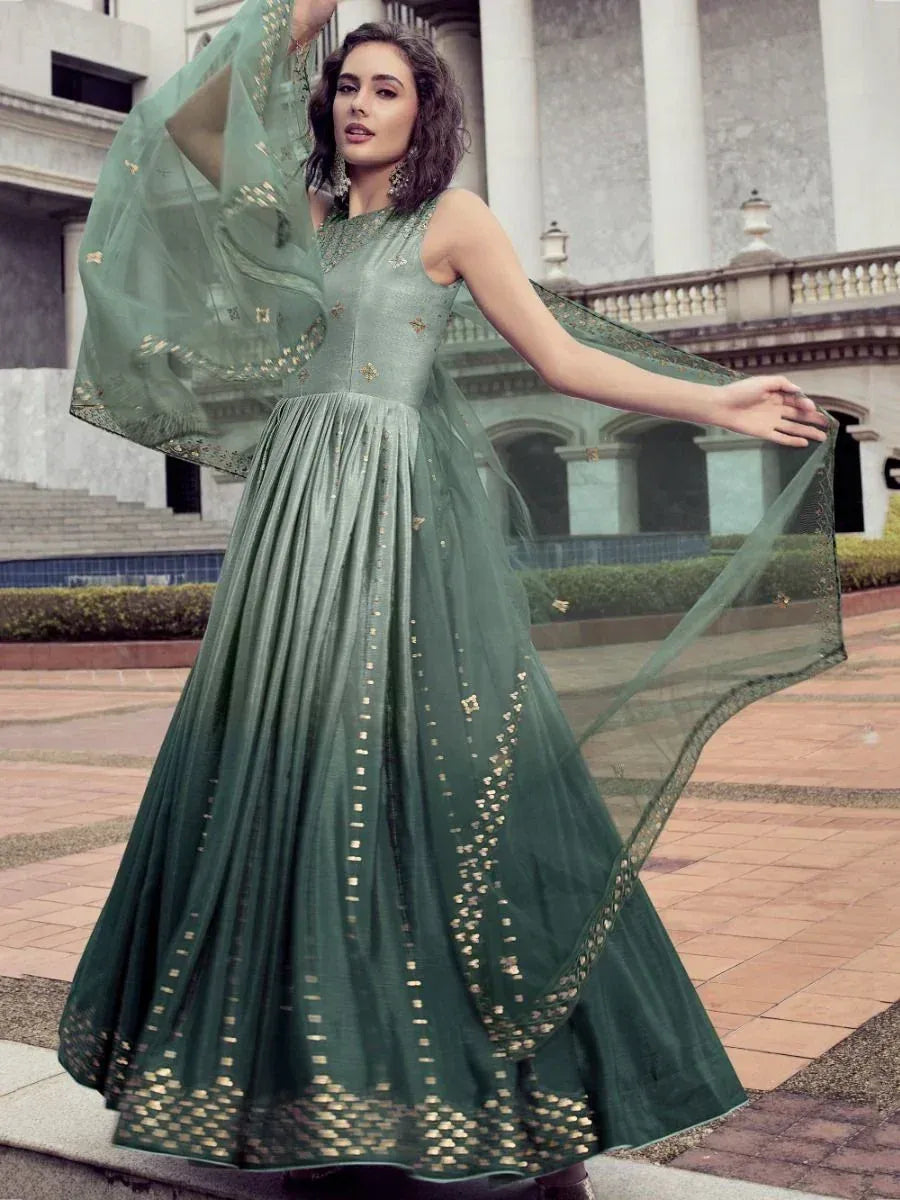 Elegant green ethnic gown with gold embroidery, perfect for Indian weddings and festive occasions.