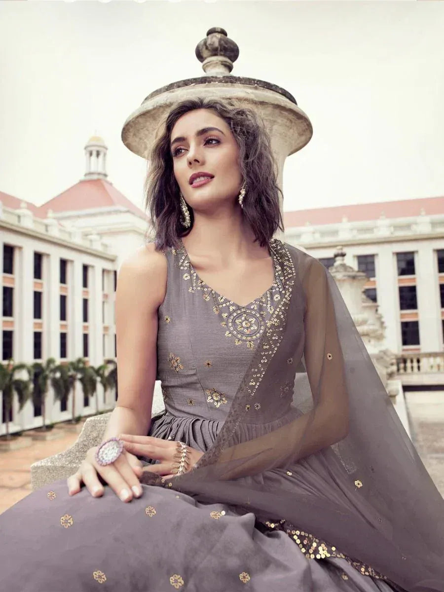 Grey embroidered ethnic gown with sheer dupatta, perfect for Indian weddings and festive occasions.
