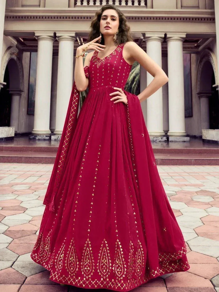 Elegant maroon ethnic gown with gold embroidery, perfect for Indian weddings and festive occasions