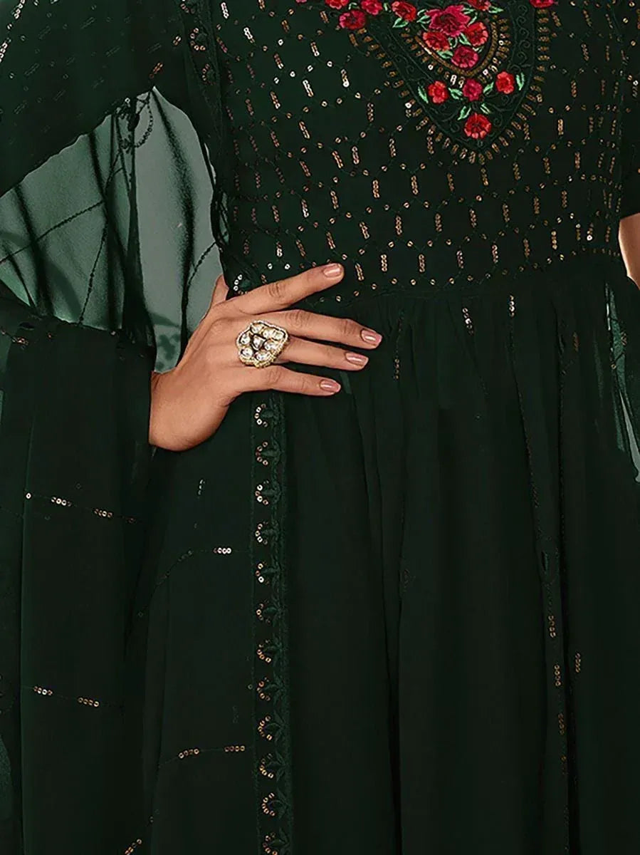 Dark green ethnic gown with sequin work, floral embroidery, and statement ring