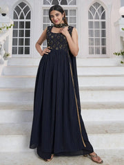 Woman in navy blue embroidered ethnic gown posing on white steps, Ethnic Plus Indian wear
