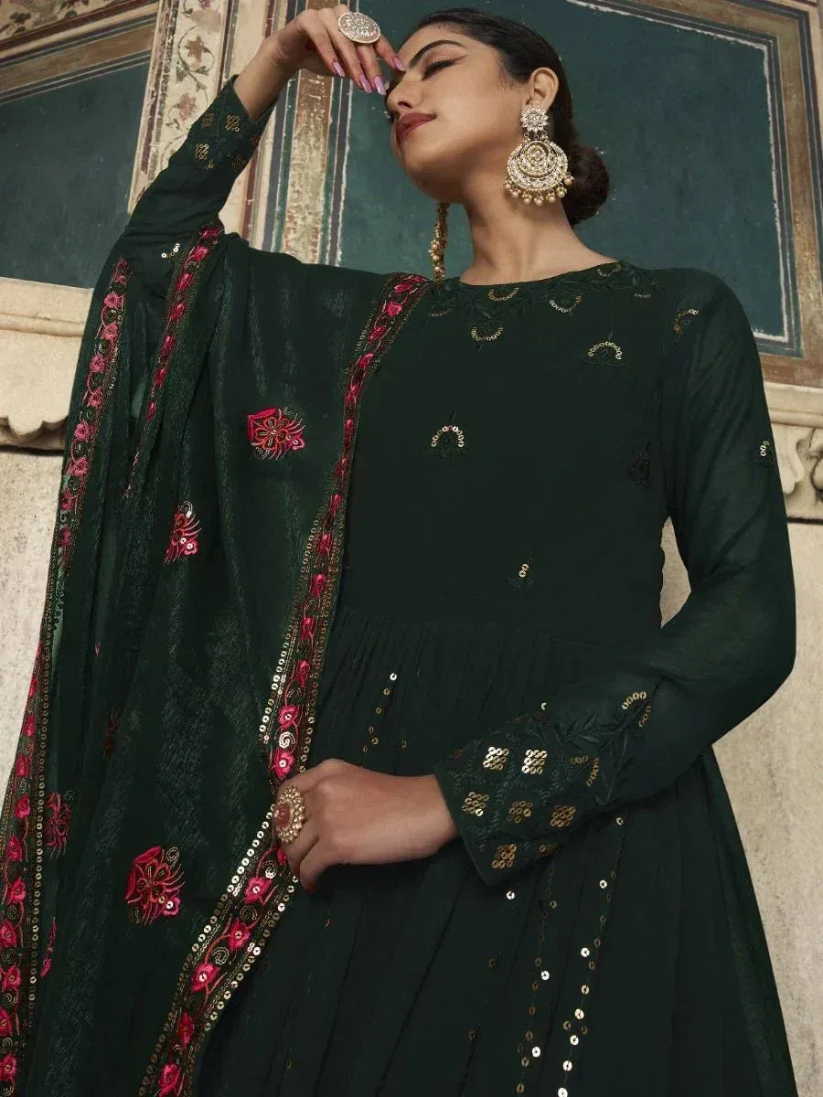 Elegant dark green ethnic gown with pink and gold embroidery, perfect for Indian occasions