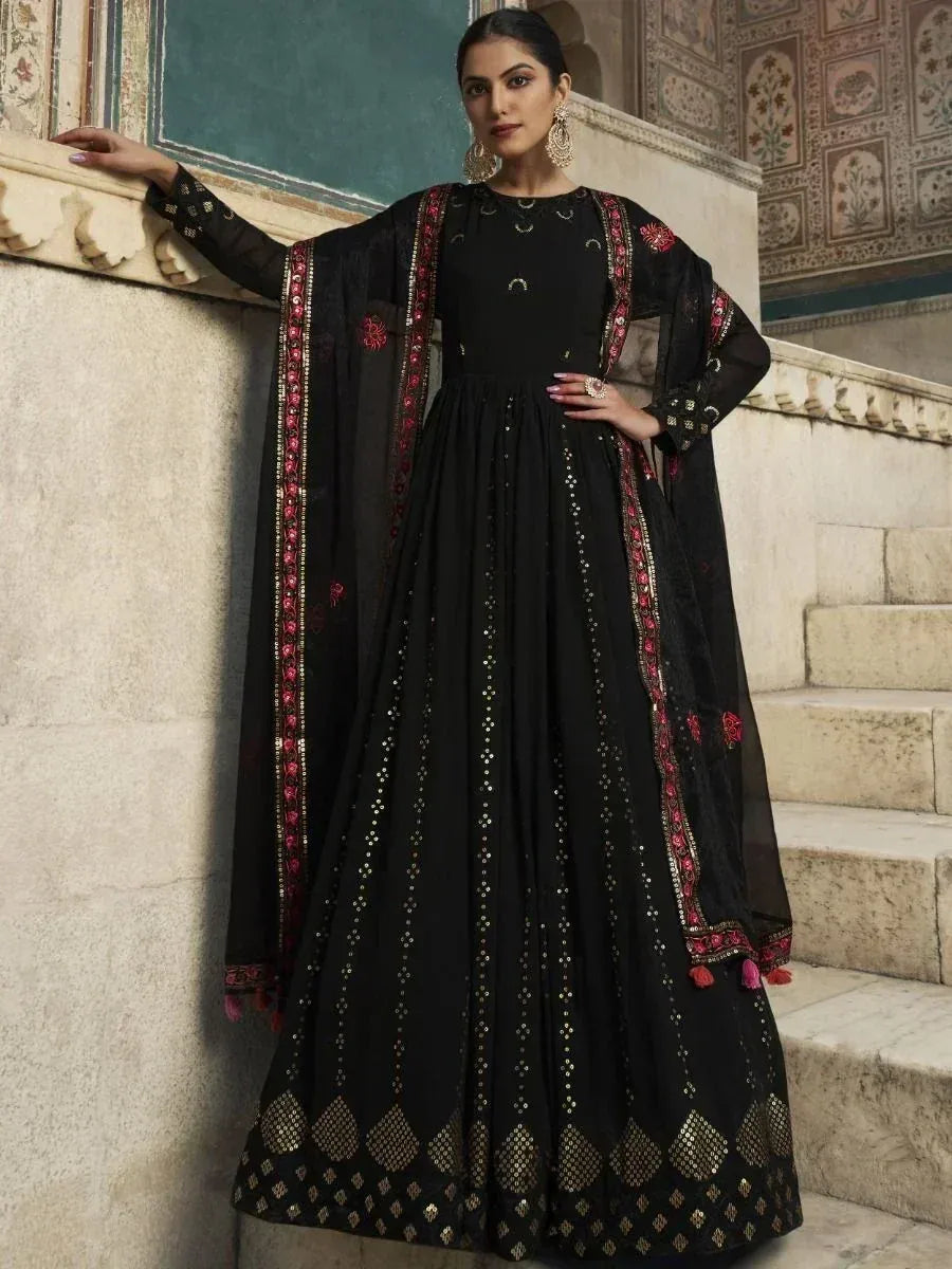 Black designer anarkali suit with gold embroidery and red floral detailing, perfect for Indian ethnic occasions.