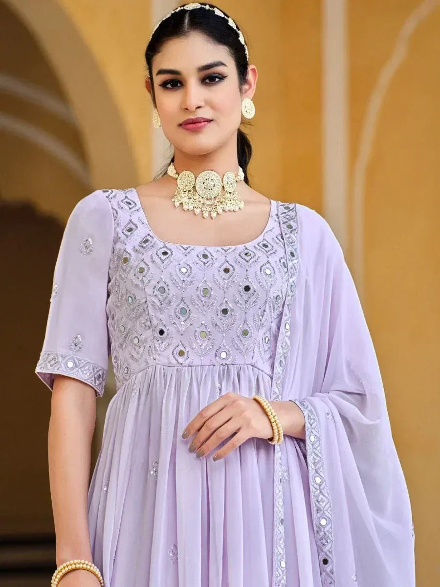 Woman in lavender embroidered Anarkali ethnic gown with matching dupatta and jewelry