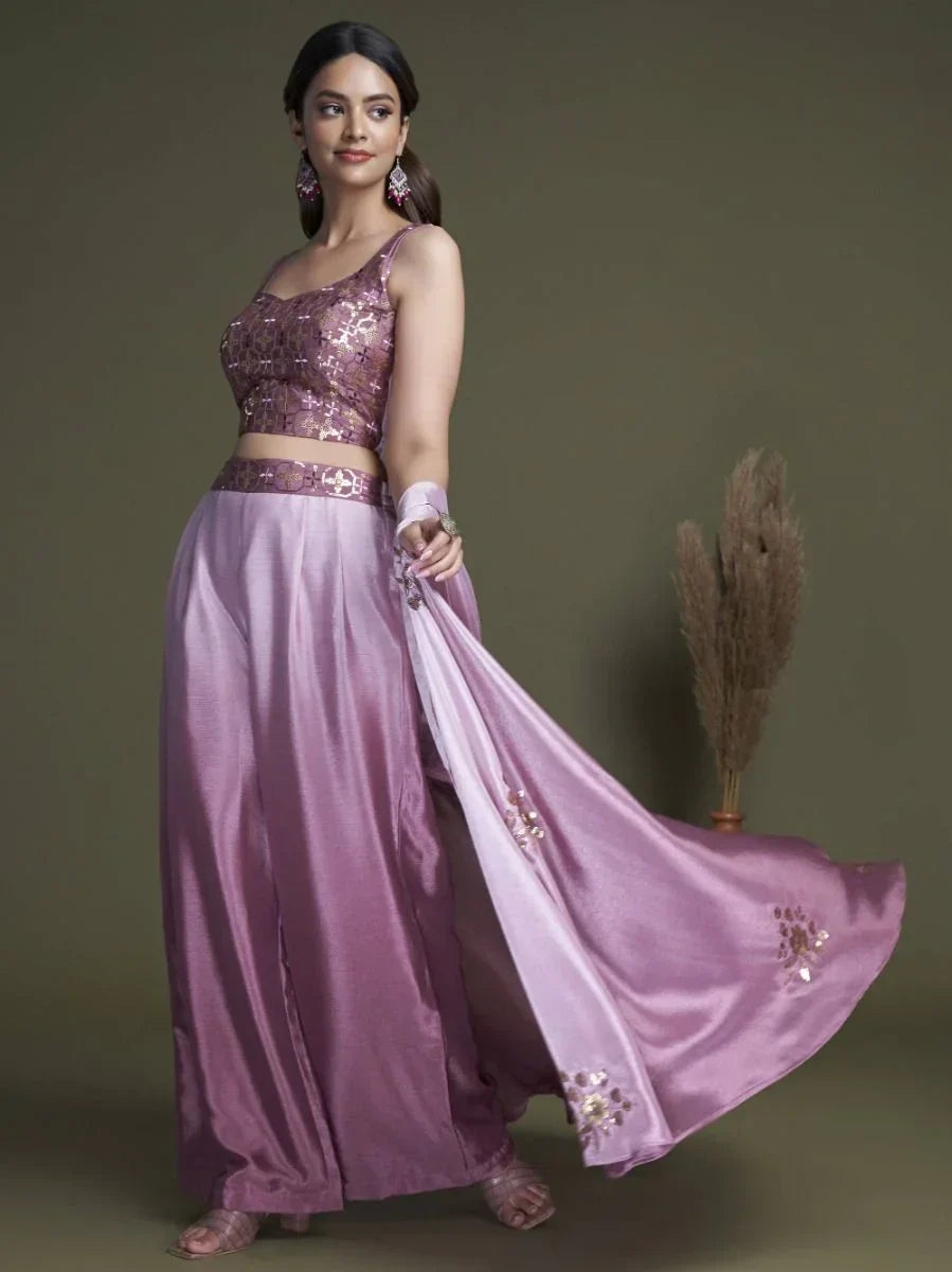 Woman wearing a lavender designer lehenga choli with sequin work and matching dupatta