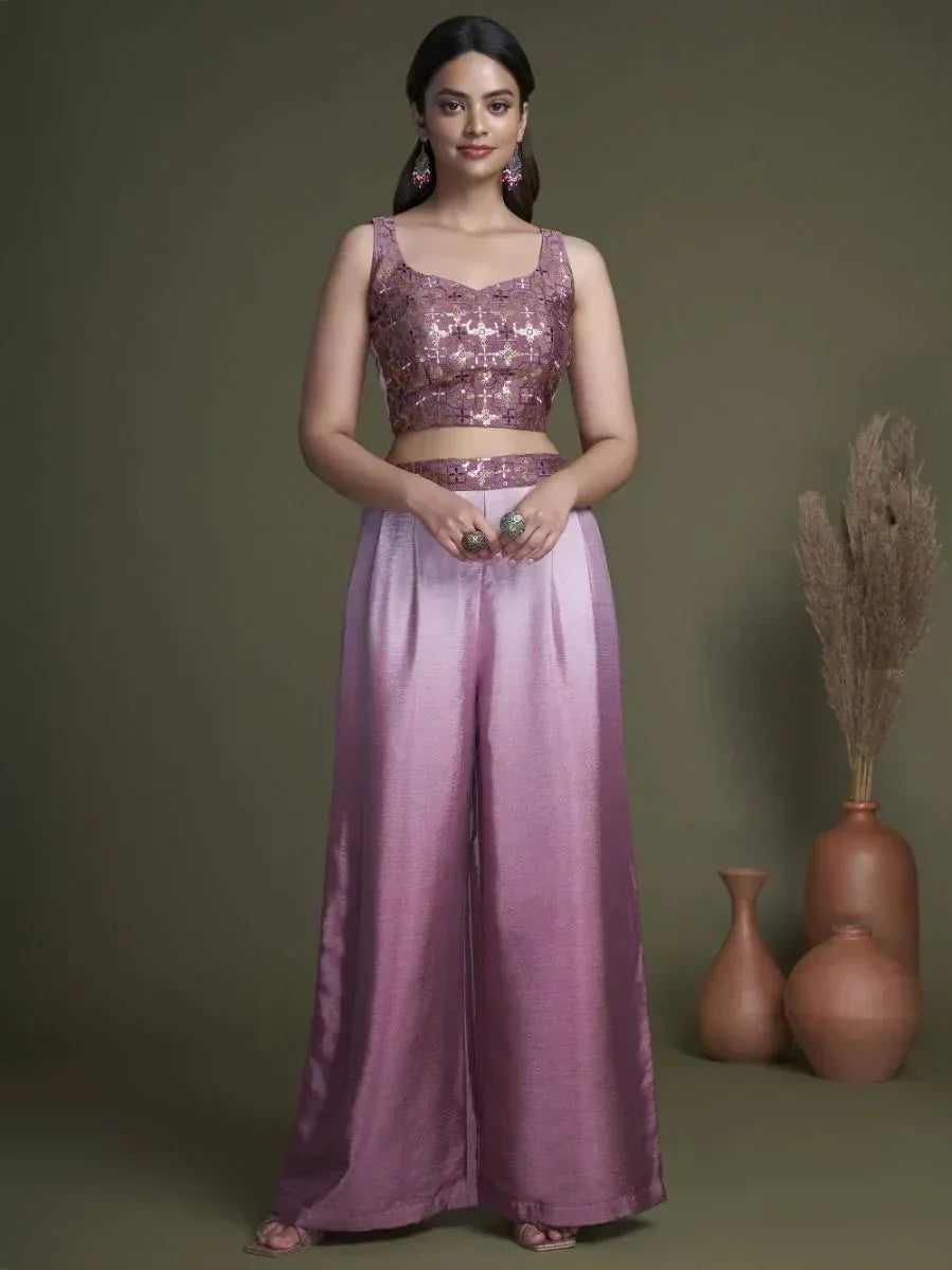 Woman wearing a mauve sequin crop top and satin palazzo pants, Indian ethnic style.