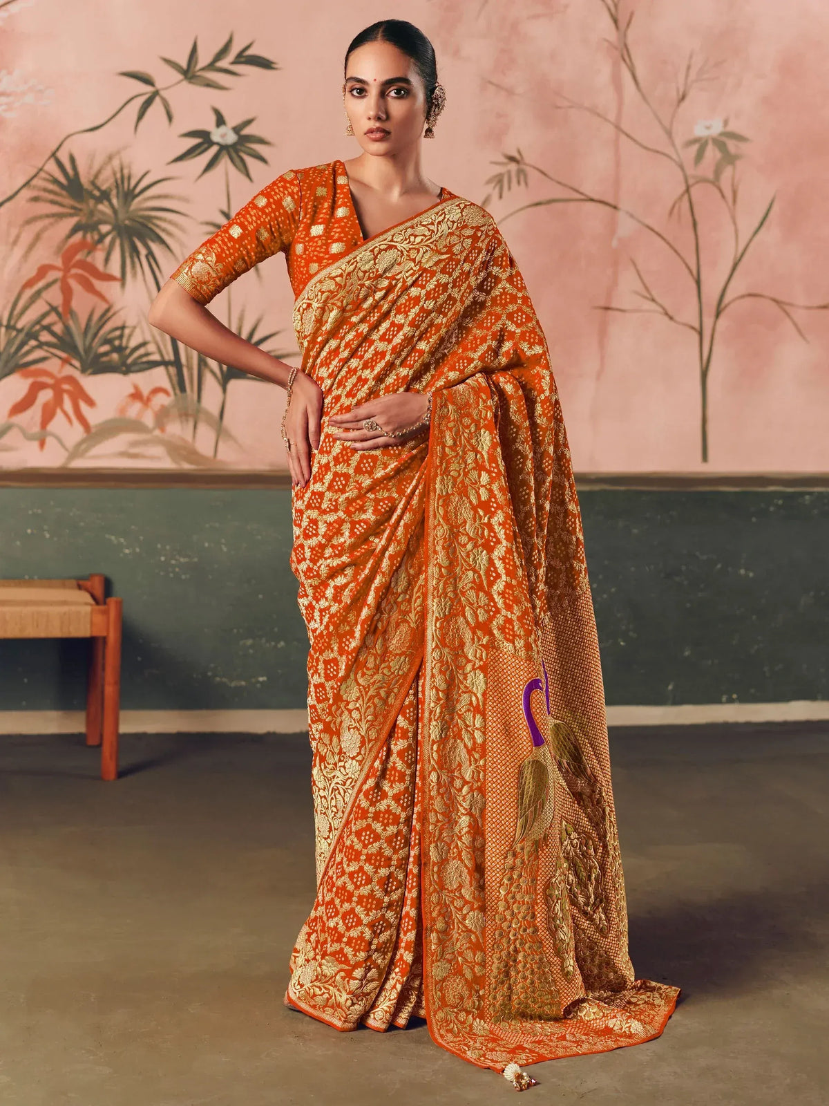 Orange and gold embroidered saree with peacock design, perfect for ethnic occasions