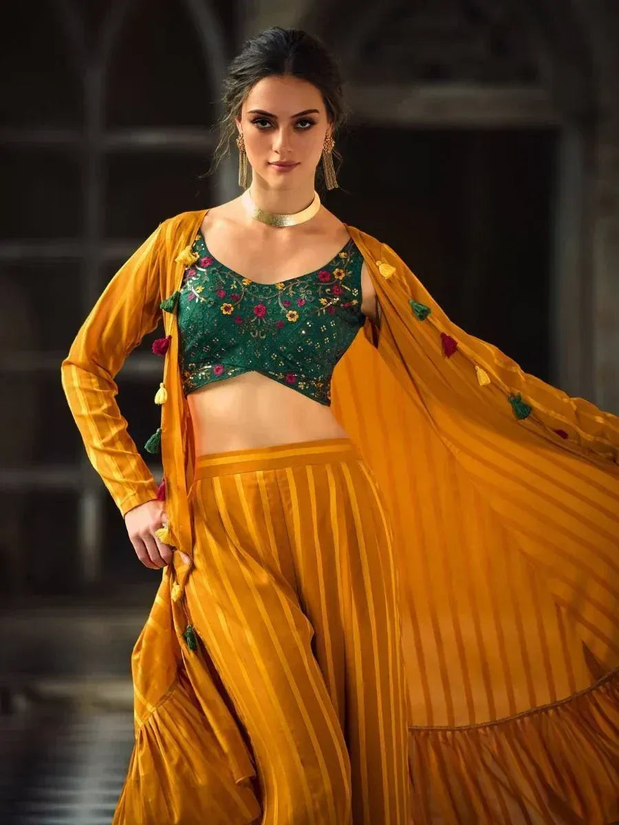 Woman wearing mustard yellow striped ethnic jacket and palazzo set with green embroidered crop top
