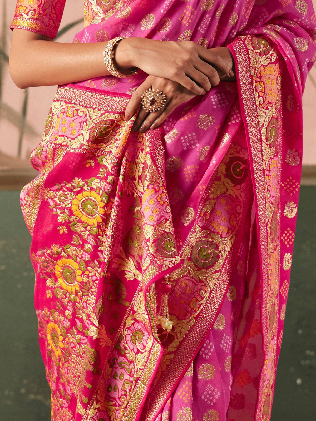 Pink floral embroidered saree with gold zari border, perfect for Indian ethnic wear occasions