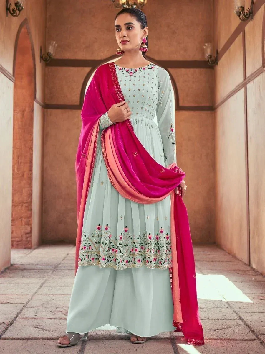 Woman in pastel green palazzo suit with floral embroidery and pink dupatta, Indian ethnic wear