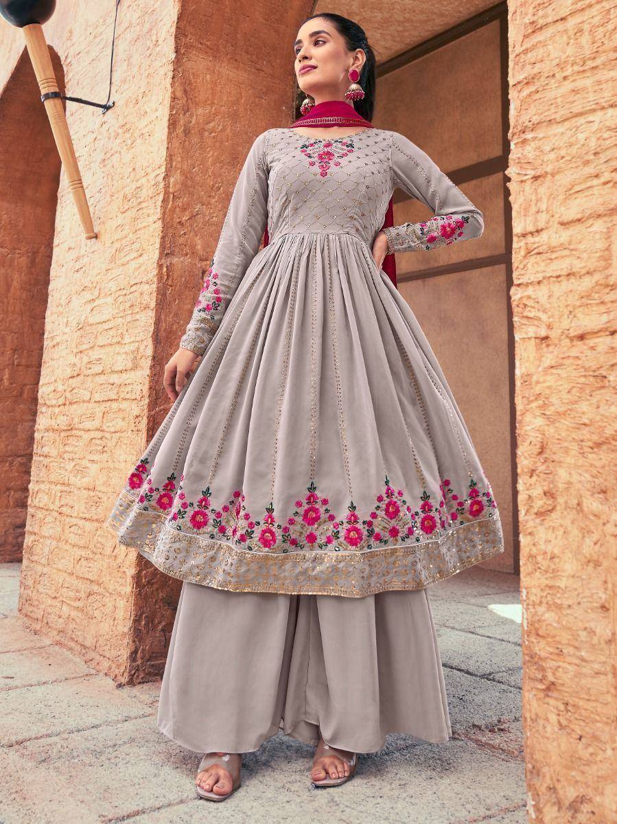 Woman wearing a grey embroidered Anarkali suit with floral designs and palazzo pants