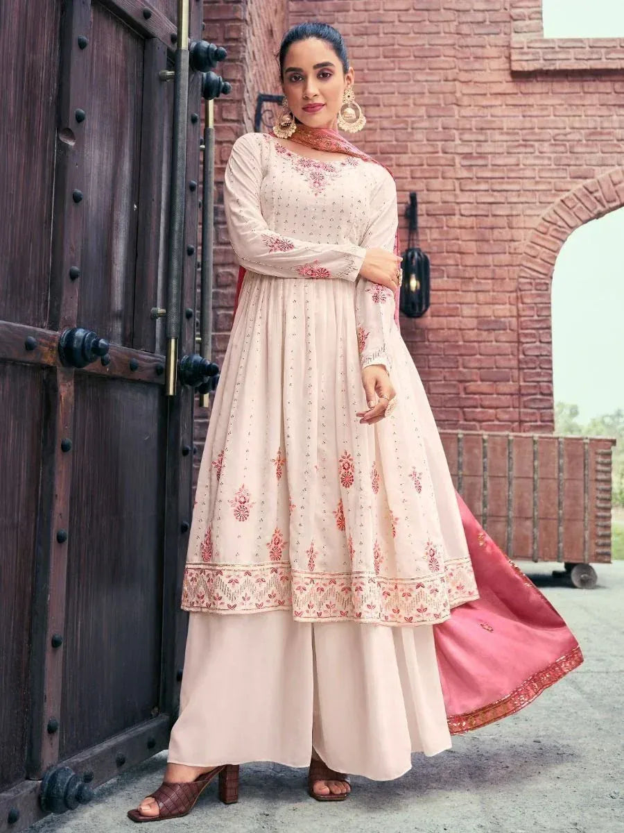 Woman in cream and pink embroidered Anarkali suit with palazzo pants and dupatta