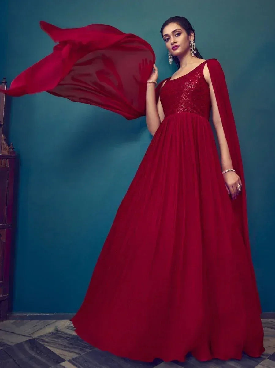 Elegant red ethnic gown with flowing cape, perfect for Indian celebrations and festive occasions.