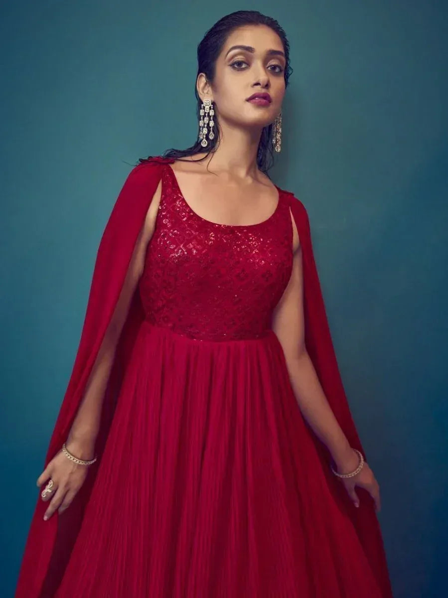 Red ethnic gown with cape, sequin bodice, and pleated skirt for Indian occasions