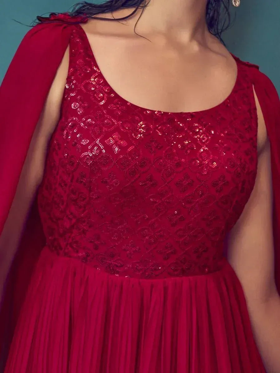 Red sequined ethnic gown with pleated skirt and cape sleeves