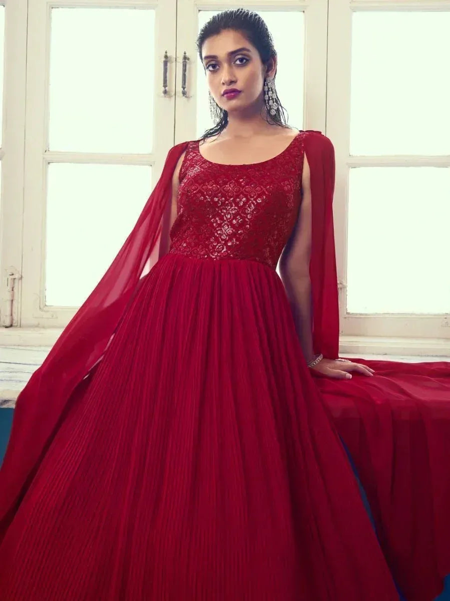 Red ethnic gown with lace bodice and cape sleeves, perfect for Indian weddings and parties